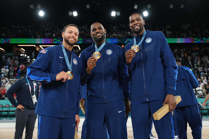 PARIS, FRANCE - AUGUST 10: Stephen Curry #4, LeBron James #6, and Kevin Durant #7 of Team USA pose for a photo after winning the gold medal during the Men's Gold Medal Game on August 10, 2024 at the AccorHotels Arena in Paris, France. NOTE TO USER: User expressly acknowledges and agrees that, by downloading and/or using this photograph, user is consenting to the terms and conditions of the Getty Images License Agreement. Mandatory Copyright Notice: Copyright 2024 NBAE (Photo by Jesse D. Garrabrant/NBAE via Getty Images)