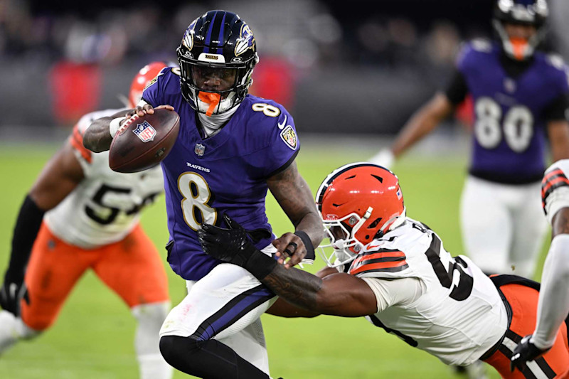 BALTIMORE, MARYLAND - JANUARY 04: Lamar Jackson #8 of the Baltimore Ravens runs with the ball while defended by Winston Reid #59 of the Cleveland Browns during the first quarter at M&T Bank Stadium on January 04, 2025 in Baltimore, Maryland. (Photo by Greg Fiume/Getty Images)