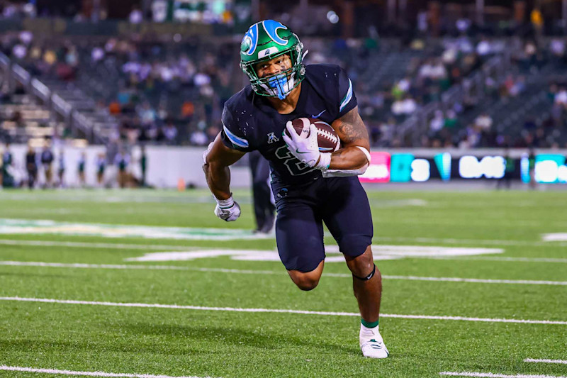 CHARLOTTE, NORTH CAROLINA - OCTOBER 31: Makhi Hughes #21 of the Tulane Green Wave runs the ball during the second half of a football game against the Charlotte 49ers at Jerry Richardson Stadium on October 31, 2024 in Charlotte, North Carolina.  (Photo by David Jensen/Getty Images)