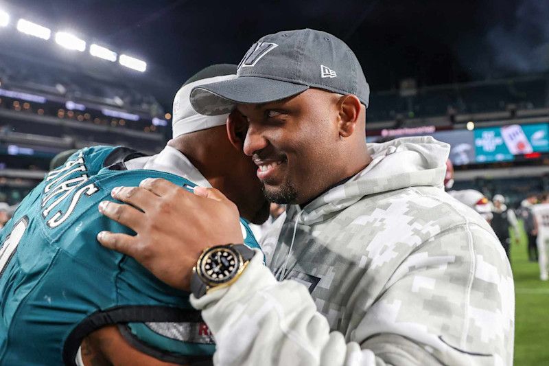 PHILADELPHIA, PENNSYLVANIA - NOVEMBER 14: Jalen Hurts #1 of the Philadelphia Eagles hugs Brian Johnson, assistant head coach and offensive pass game coordinator of the Washington Commanders after the game at Lincoln Financial Field on November 14, 2024 in Philadelphia, Pennsylvania. The Eagles won 26-18. (Photo by Elsa/Getty Images)