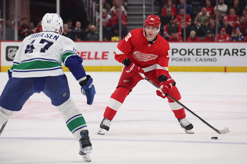 DETROIT, MICHIGAN - FEBRUARY 10: Patrick Kane #88 of the Detroit Red Wings looks to pass around Noah Juulsen #47 of the Vancouver Canucks during the second period at Little Caesars Arena on February 10, 2024 in Detroit, Michigan. Detroit won the game 4-3 in overtime. (Photo by Gregory Shamus/Getty Images)