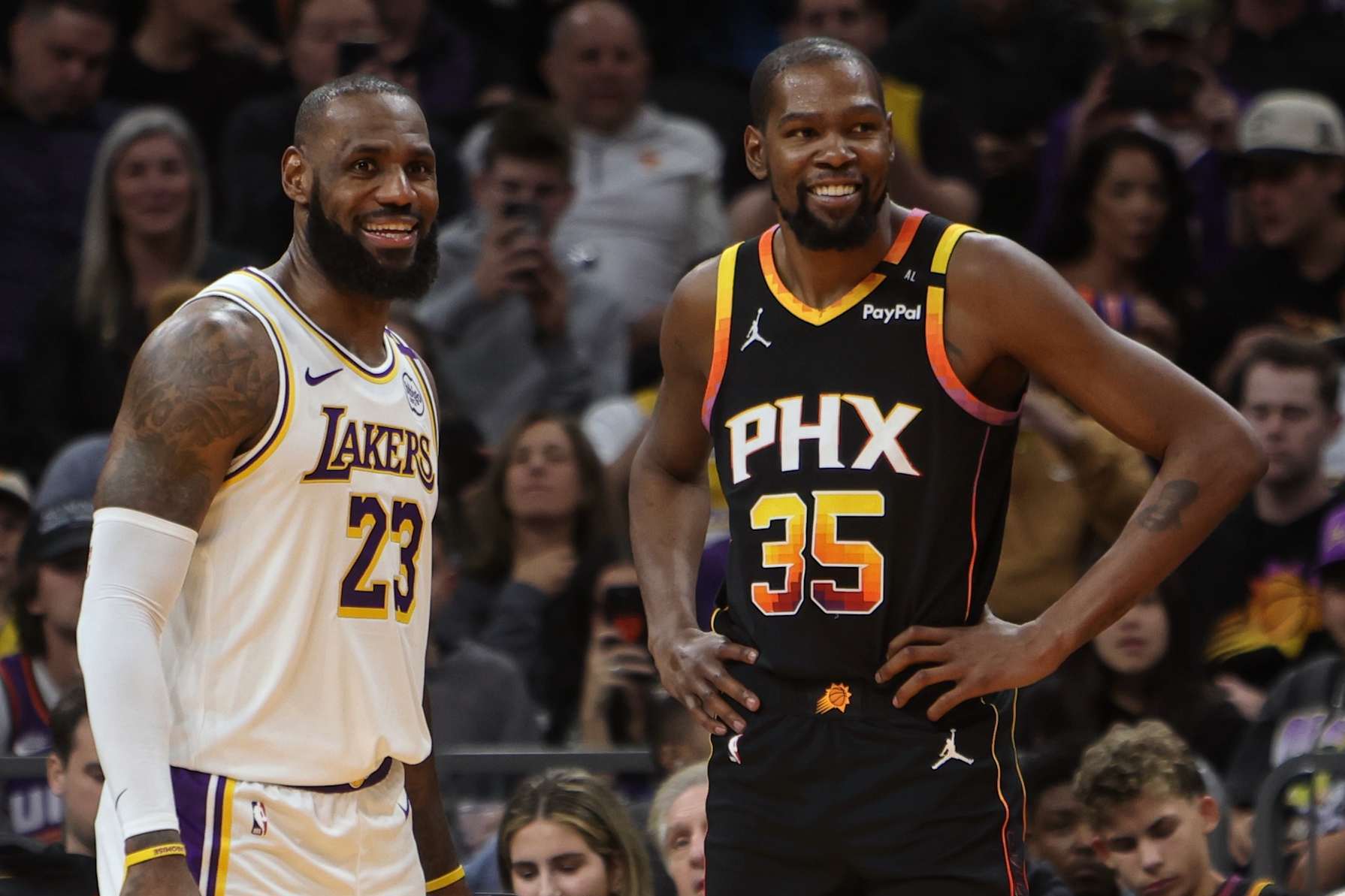 PHOENIX, AZ - NOVEMBER 26: LeBron James #23 of the Los Angeles Lakers and Kevin Durant #35 of the Phoenix Suns look on during the game on November 26, 2024 at Footprint Center in Phoenix, Arizona. NOTE TO USER: User expressly acknowledges and agrees that, by downloading and or using this photograph, user is consenting to the terms and conditions of the Getty Images License Agreement. Mandatory Copyright Notice: Copyright 2024 NBAE (Photo by Jim Poorten/NBAE via Getty Images)