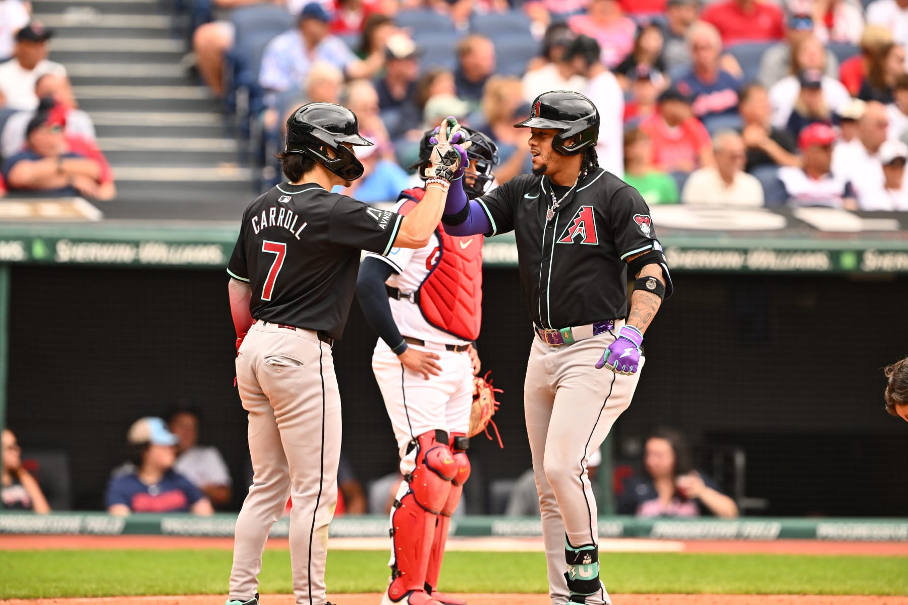 CLEVELAND, OHIO - AUGUST 07: Corbin Carroll #7 celebrates with Ketel Marte #4 of the Arizona Diamondbacks after both scored on a homer by Marte during the ninth inning of game one of a doubleheader against the Cleveland Guardians at Progressive Field on August 07, 2024 in Cleveland, Ohio. (Photo by Jason Miller/Getty Images)