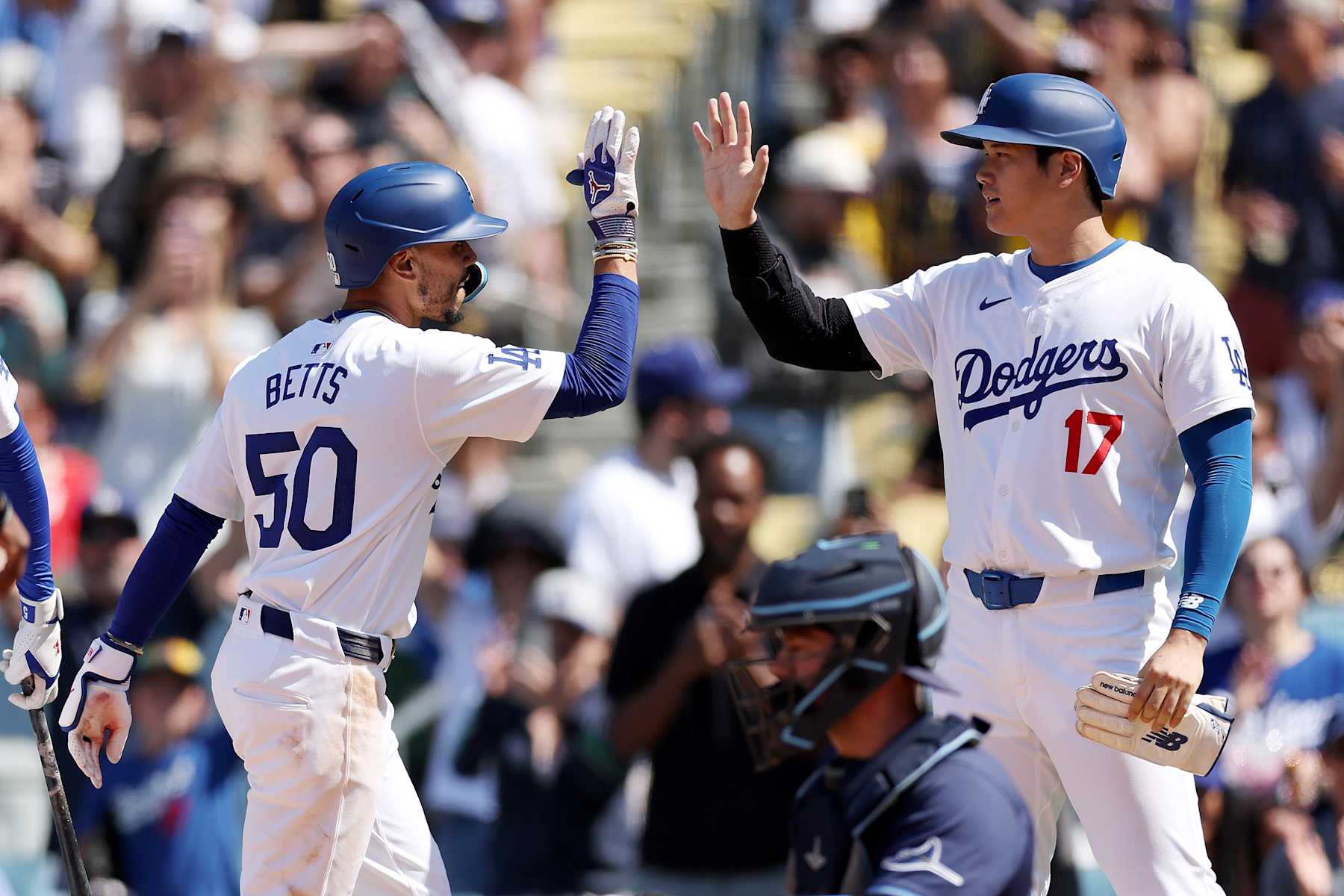 LOS ANGELES, CALIFORNIA - AUGUST 25: Mookie Betts #50 of the Los Angeles Dodgers celebrates his two run home run with teammate Shohei Ohtani #17 during the eighth inning against the Tampa Bay Rays at Dodger Stadium on August 25, 2024 in Los Angeles, California. (Photo by Katelyn Mulcahy/Getty Images) LOS ANGELES, CALIFORNIA - AUGUST 25: Mookie Betts #50 of the Los Angeles Dodgers celebrates his two run home run with teammate Shohei Ohtani #17 during the eighth inning against the Tampa Bay Rays at Dodger Stadium on August 25, 2024 in Los Angeles, California. (Photo by Katelyn Mulcahy/Getty Images)