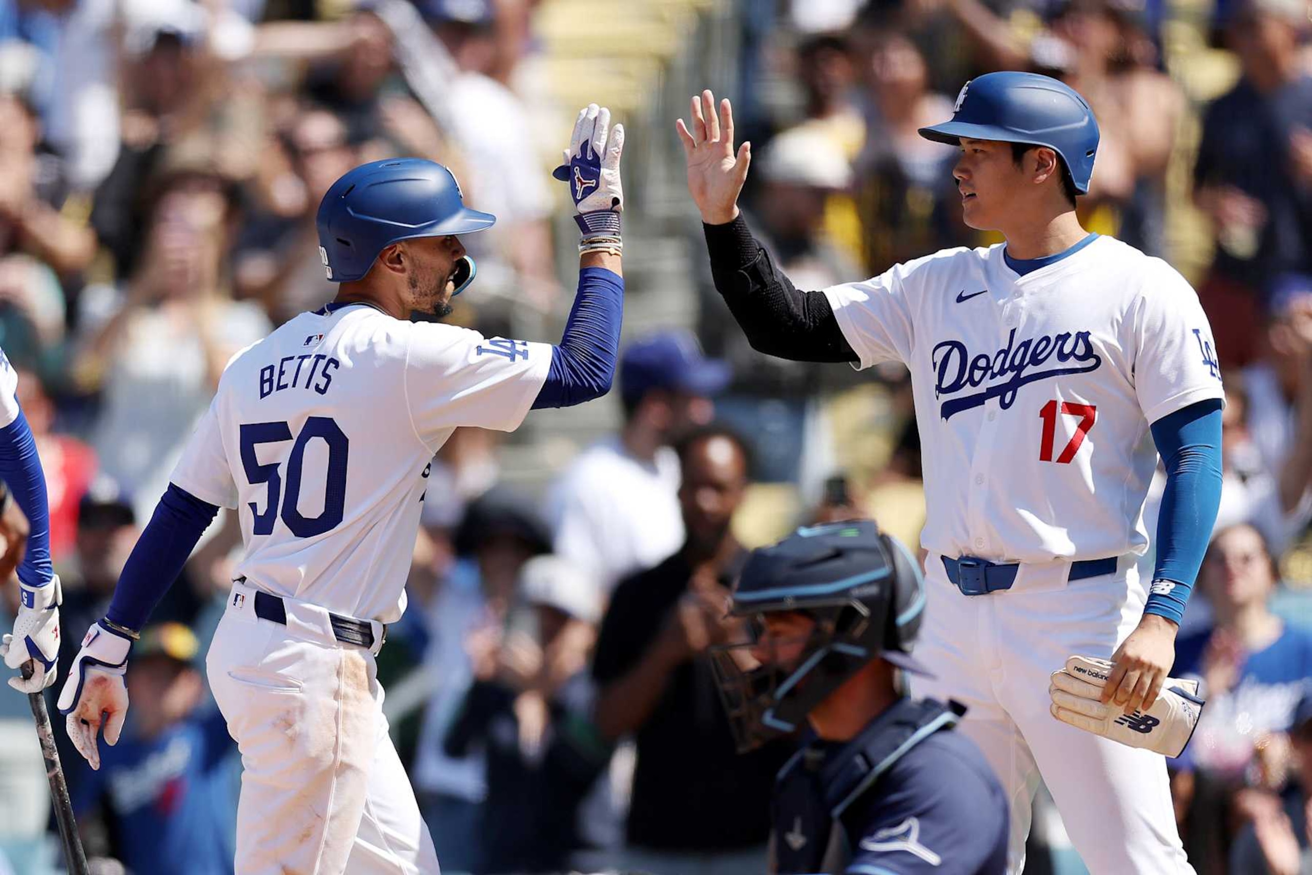 LOS ANGELES, CALIFORNIA - AUGUST 25: Mookie Betts #50 of the Los Angeles Dodgers celebrates his two run home run with teammate Shohei Ohtani #17 during the eighth inning against the Tampa Bay Rays at Dodger Stadium on August 25, 2024 in Los Angeles, California. (Photo by Katelyn Mulcahy/Getty Images)