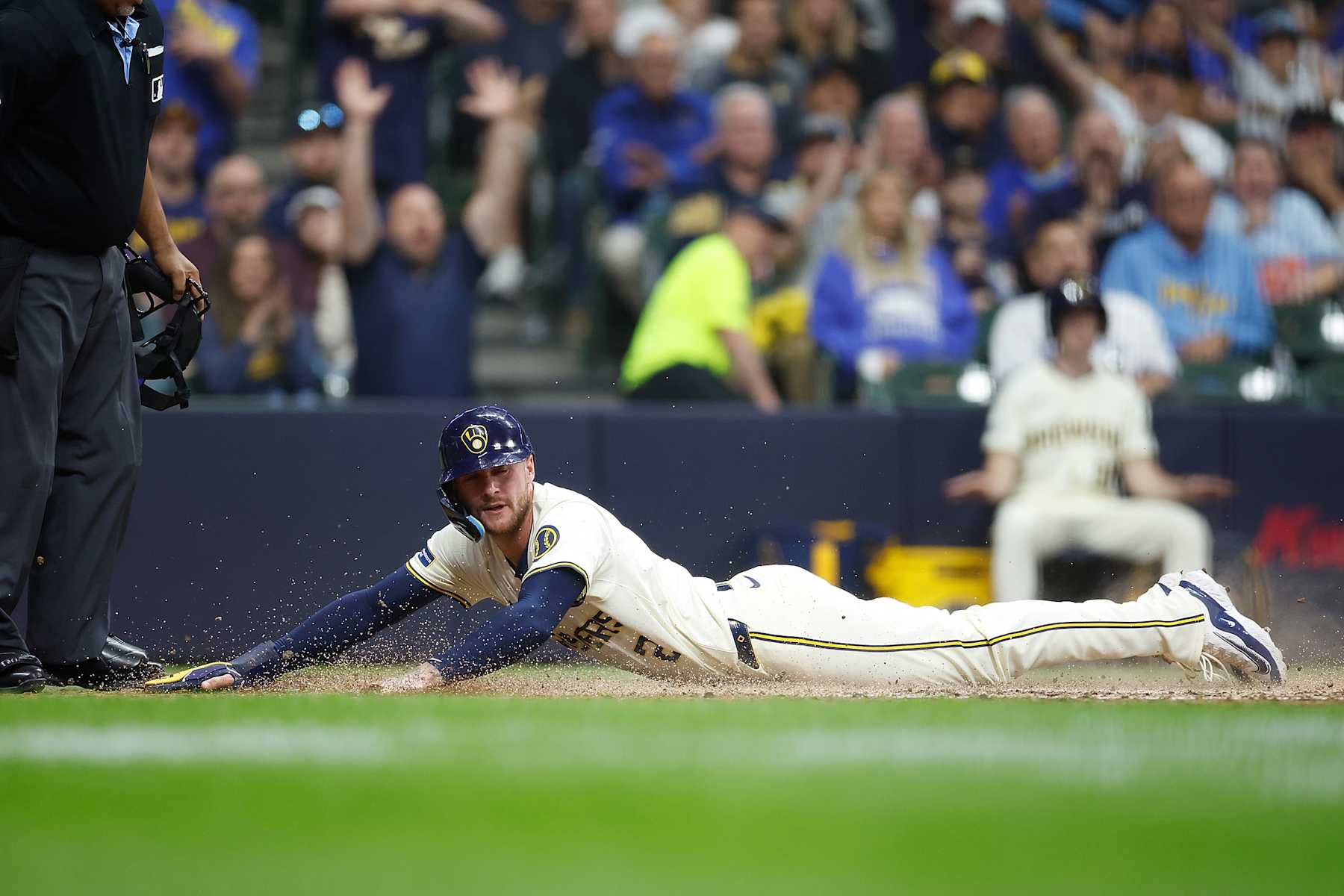 MILWAUKEE, WISCONSIN - JUNE 10: Brice Turang #2 of the Milwaukee Brewers slides safely into home plate on a sacrifice fly in the sixth inning a\t at American Family Field on June 10, 2024 in Milwaukee, Wisconsin. (Photo by John Fisher/Getty Images)