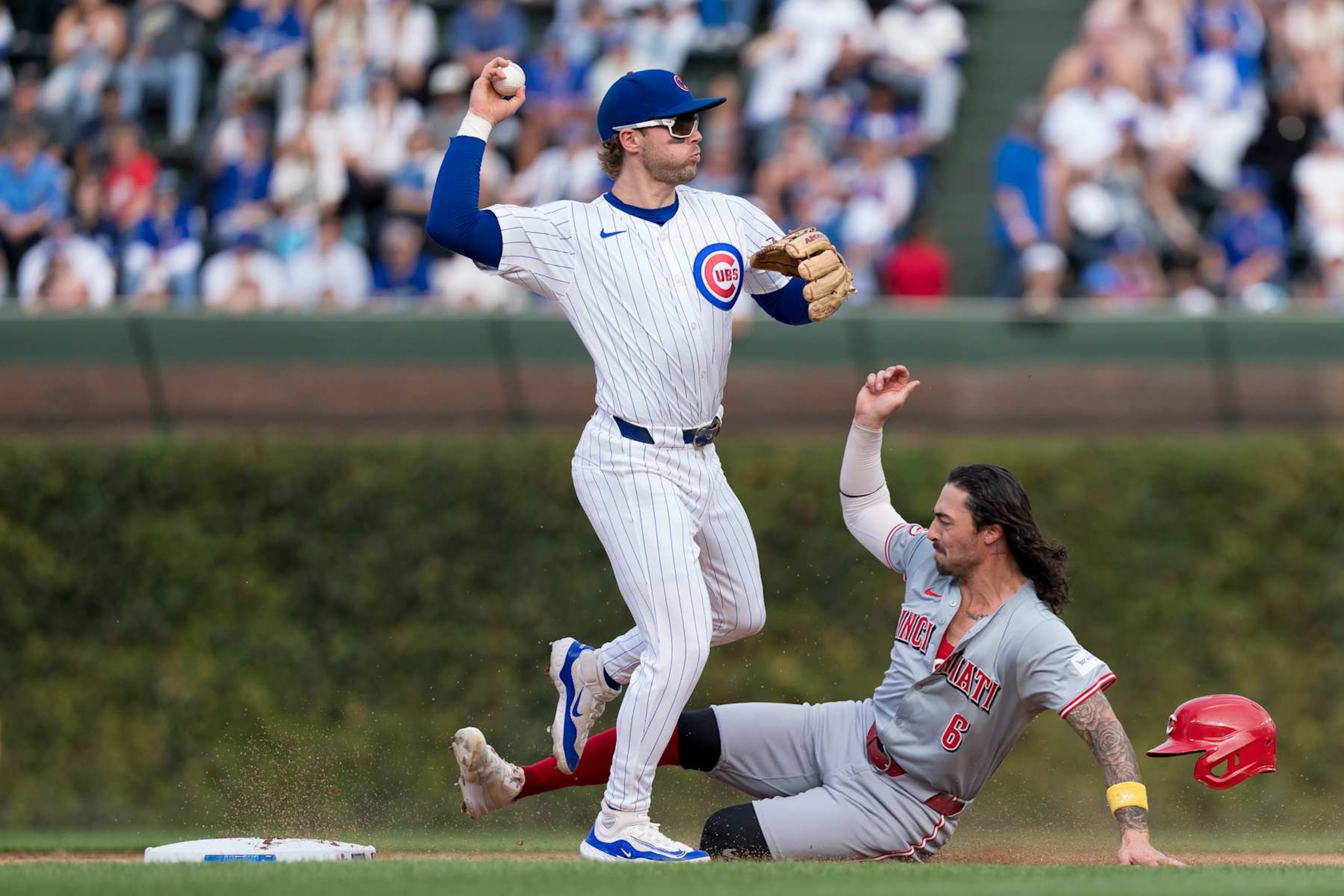 CHICAGO, ILLINOIS - SEPTEMBER 29: Nico Hoerner #2 of the Chicago Cubs turns a double play in a game against the Cincinnati Reds at Wrigley Field on September 29, 2024 in Chicago, Illinois.(Photo by Matt Dirksen/Chicago Cubs/Getty Images) CHICAGO, ILLINOIS - SEPTEMBER 29: Nico Hoerner #2 of the Chicago Cubs turns a double play in a game against the Cincinnati Reds at Wrigley Field on September 29, 2024 in Chicago, Illinois.(Photo by Matt Dirksen/Chicago Cubs/Getty Images)