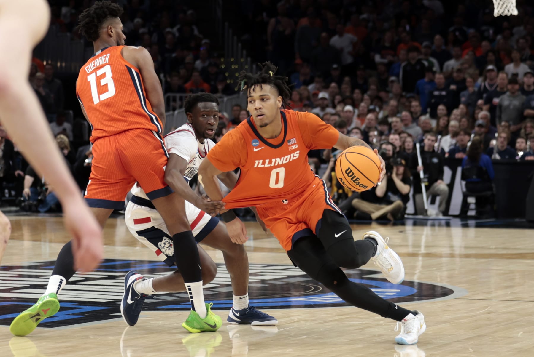 BOSTON, MA - MARCH 30: Illinois Fighting Illini guard Terrence Shannon Jr. (0) has his jersey pulled by UCONN Huskies guard Hassan Diarra (10) on a drive to the hoop during the NCAA Elite Eight, East Regional Final between the UCONN Huskies and the Illinois Fighting Illini on March 30, 2024, at TD Garden in Boston, Massachusetts. (Photo by Fred Kfoury III/Icon Sportswire via Getty Images)