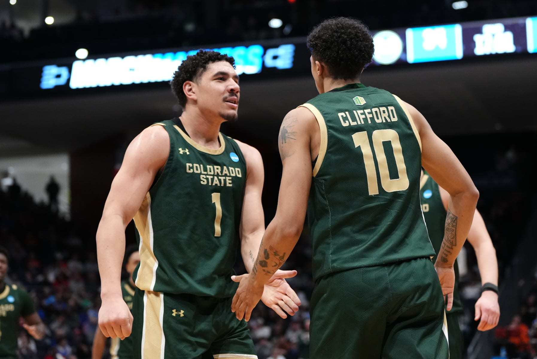 DAYTON, OHIO - MARCH 19: Joel Scott #1 and Nique Clifford #10 of the Colorado State Rams celebrate after a basket and foul during the second half against the Virginia Cavaliers in the First Four game during the NCAA Men's Basketball Tournament at University of Dayton Arena on March 19, 2024 in Dayton, Ohio. (Photo by Dylan Buell/Getty Images)