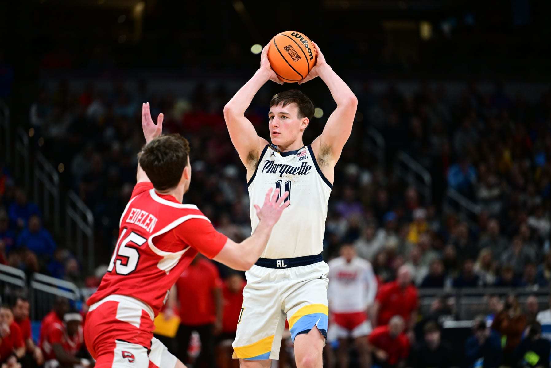 INDIANAPOLIS, INDIANA - MARCH 22: Tyler Kolek #11 of the Marquette Golden Eagles passes the ball against Jack Edelen #15 of the Western Kentucky Hilltoppers during the first round of the 2024 NCAA Men's Basketball Tournament held at Gainbridge Fieldhouse on March 22, 2024 in Indianapolis, Indiana. (Photo by Ben Solomon/NCAA Photos via Getty Images)