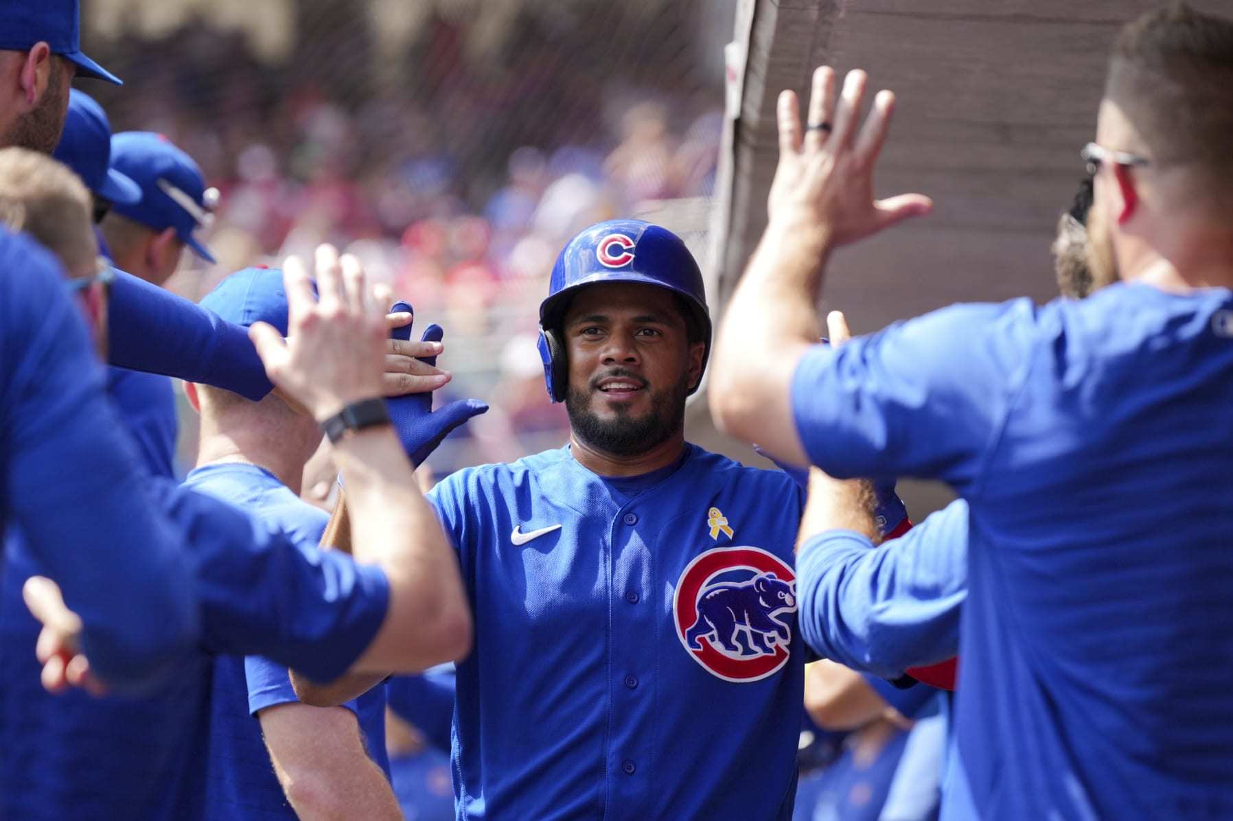 Chicago Cubs' Jeimer Candelario high-fives teammates in the dugout during a baseball game against the Cincinnati Reds in Cincinnati, Sunday, Sept. 3, 2023. (AP Photo/Aaron Doster)