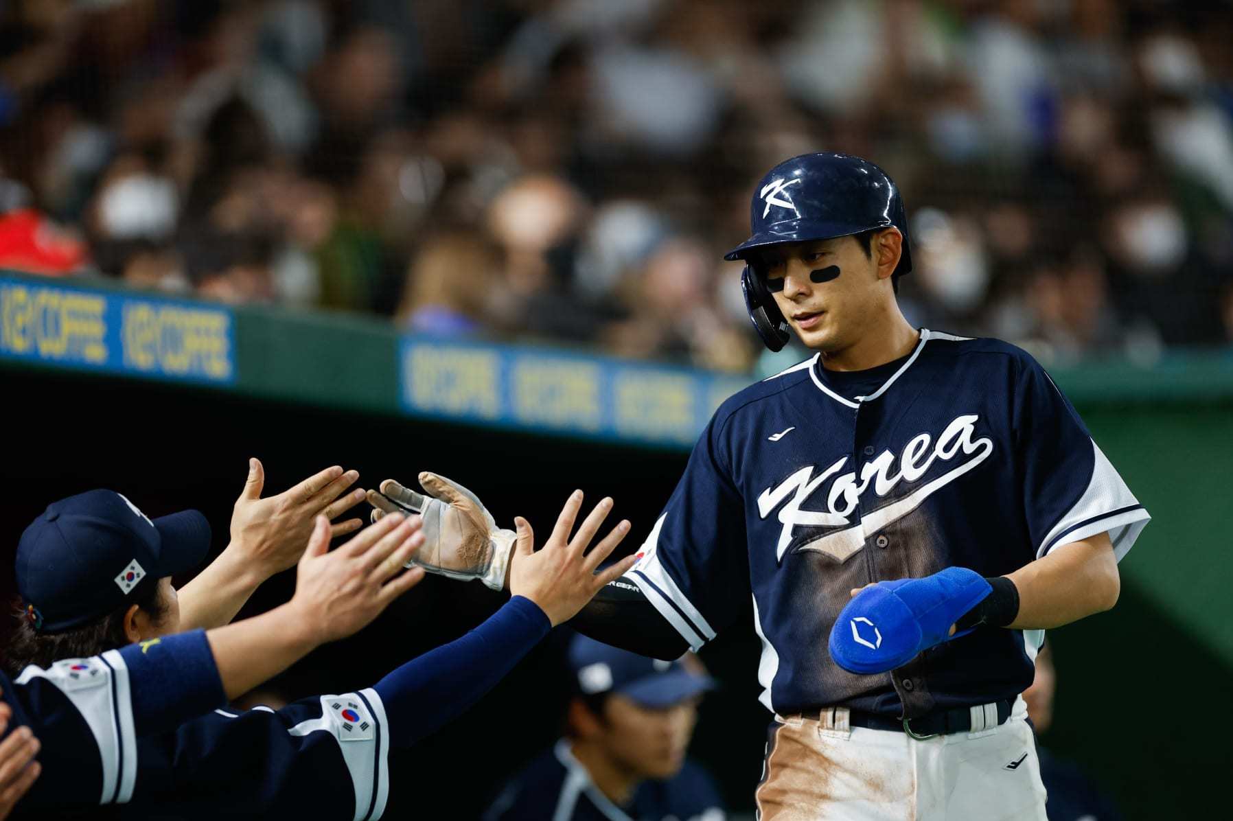 BUNKYO CITY, JAPAN - MARCH 13: Jung Hoo Lee #51 of Team Korea high-fives teammates after scoring in the first inning during Game 10 of Pool B between Team Korea and Team China at Tokyo Dome on Monday, March 13, 2023 in Bunkyo City, Japan. (Photo by Yuki Taguchi/WBCI/MLB Photos via Getty Images)