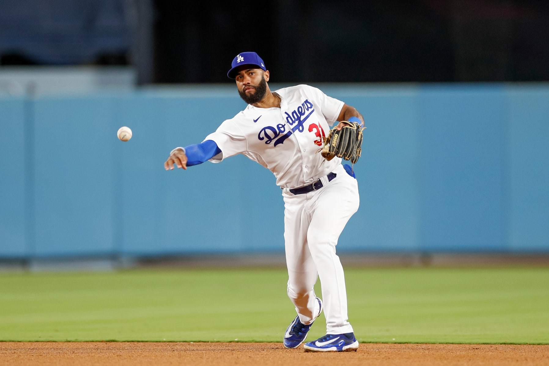 LOS ANGELES, CALIFORNIA - AUGUST 16: Amed Rosario #31 of the Los Angeles Dodgers throws on a ground out during the seventh inning against the Milwaukee Brewers at Dodger Stadium on August 16, 2023 in Los Angeles, California. (Photo by Brandon Sloter/Getty Images)
