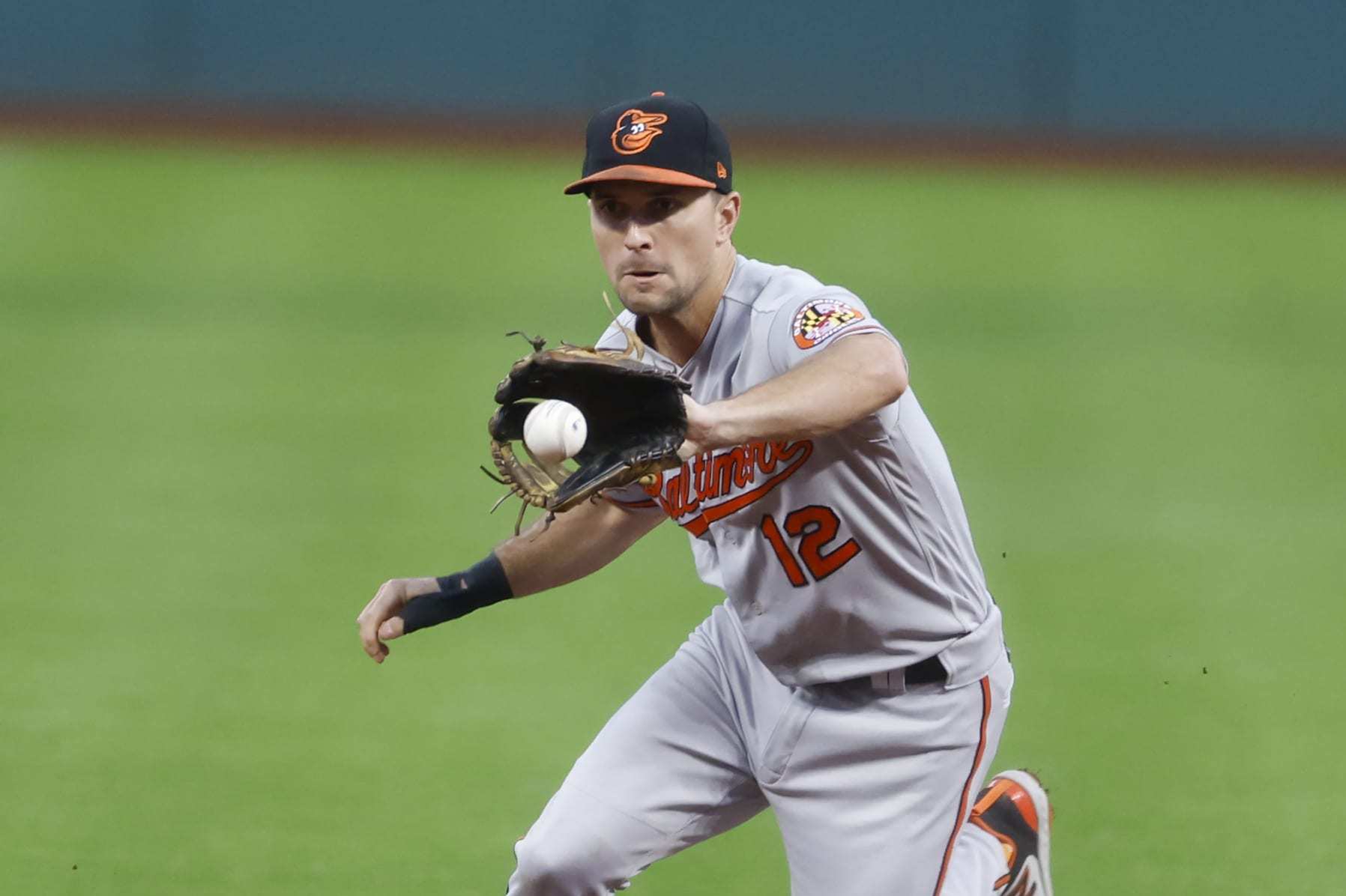 CLEVELAND, OH - SEPTEMBER 21: Adam Frazier #12 of the Baltimore Orioles fields the ball and throws out Steven Kwan #38 of the Cleveland Guardians at first base during the first inning at Progressive Field on September 21, 2023 in Cleveland, Ohio. (Photo by Ron Schwane/Getty Images)