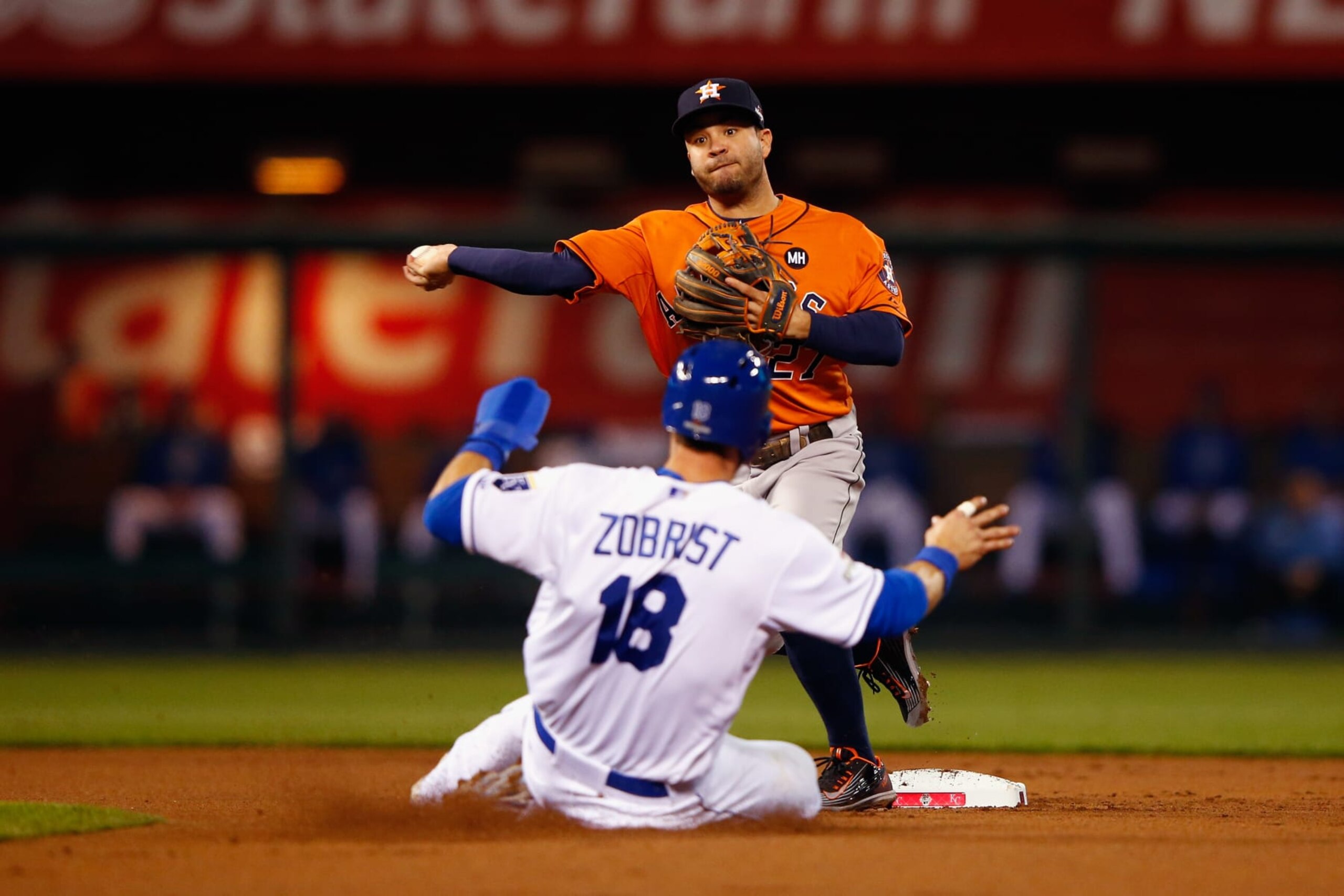 KANSAS CITY, MO - OCTOBER 14:  Ben Zobrist #18 of the Kansas City Royals is out at second base as Jose Altuve #27 of the Houston Astros throws to first base to complete the double play in the first inning during game five of the American League Divison Series at Kauffman Stadium on October 14, 2015 in Kansas City, Missouri.  (Photo by Jamie Squire/Getty Images)