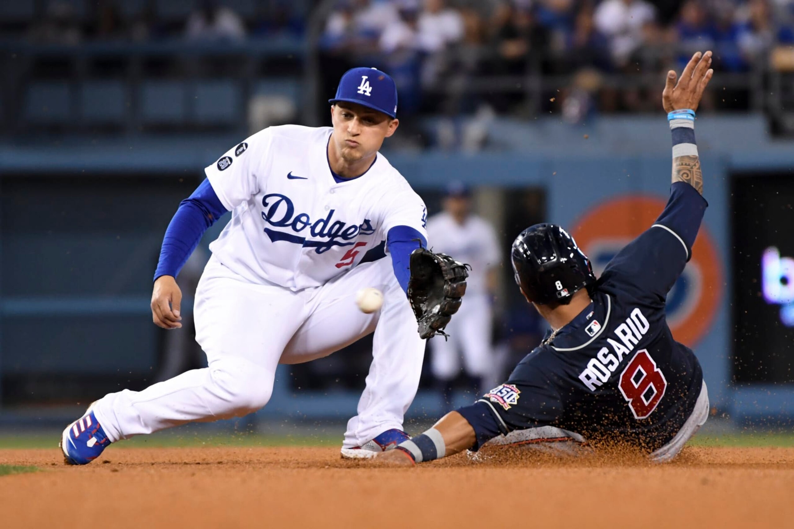 Los Angeles, CA - October 21: Los Angeles Dodgers shortstop Corey Seager, left, prepares to catch a ball while Atlanta Braves' Eddie Rosario attempts to steal second during the third inning in game five in the 2021 National League Championship Series at Dodger Stadium on Thursday, Oct. 21, 2021 in Los Angeles, CA. (Wally Skalij / Los Angeles Times via Getty Images)