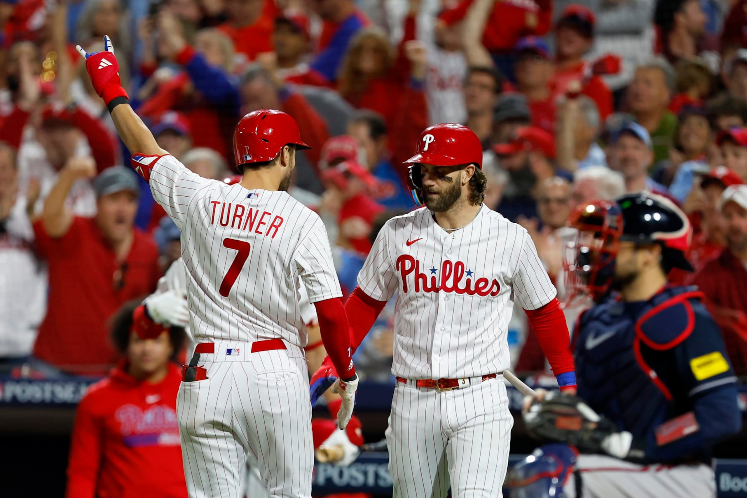 PHILADELPHIA, PENNSYLVANIA - OCTOBER 11: Trea Turner #7 of the Philadelphia Phillies celebrates with Bryce Harper #3 after hitting a solo home run against the Atlanta Braves during the sixth inning in Game Three of the Division Series at Citizens Bank Park on October 11, 2023 in Philadelphia, Pennsylvania. (Photo by Rich Schultz/Getty Images)