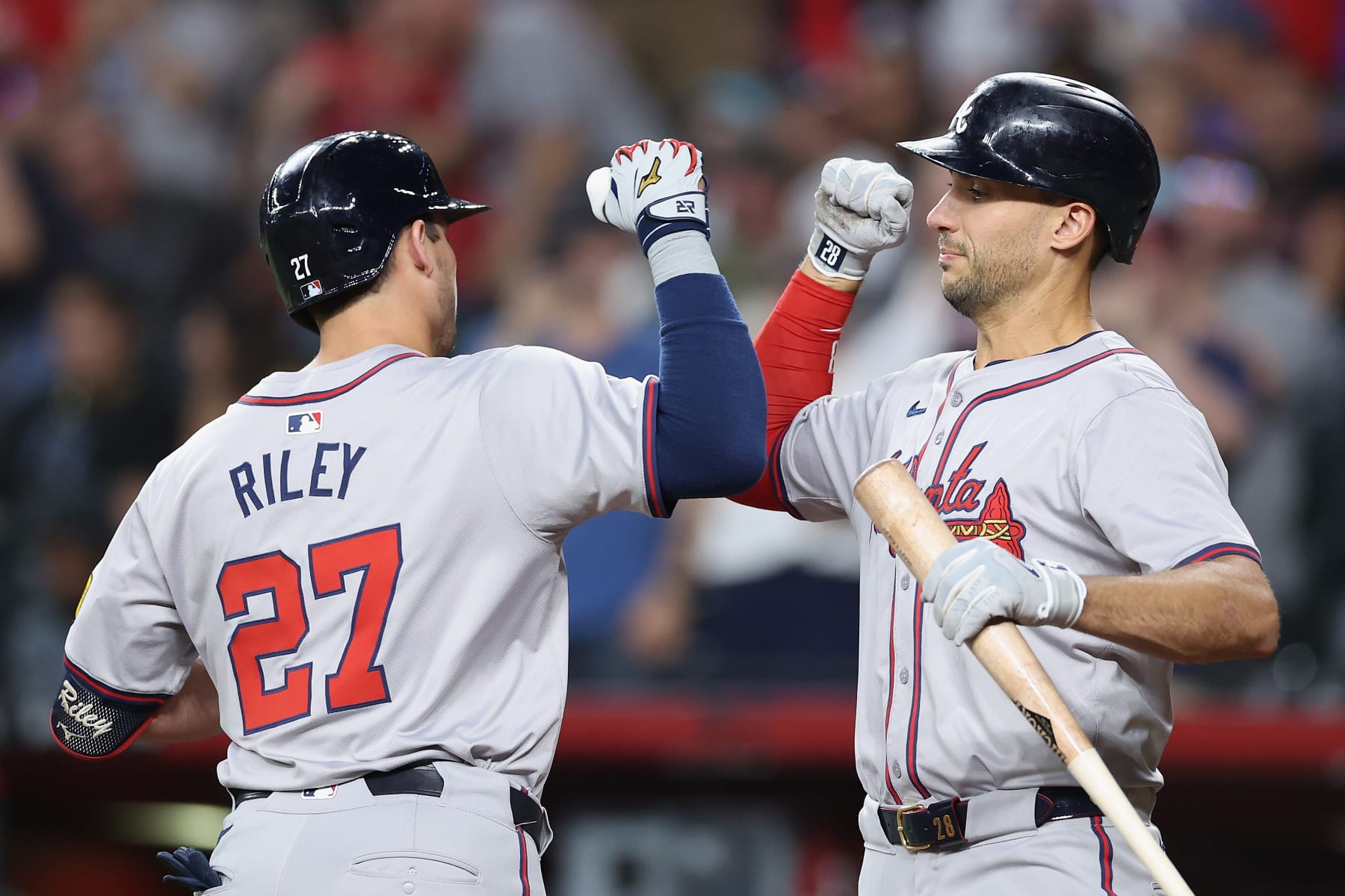 PHOENIX, ARIZONA - JULY 08: Matt Olson #28 of the Atlanta Braves high fives Austin Riley #27 after Riley hit a solo home run against the Arizona Diamondbacks during the first inning of the MLB game at Chase Field on July 08, 2024 in Phoenix, Arizona. (Photo by Christian Petersen/Getty Images)