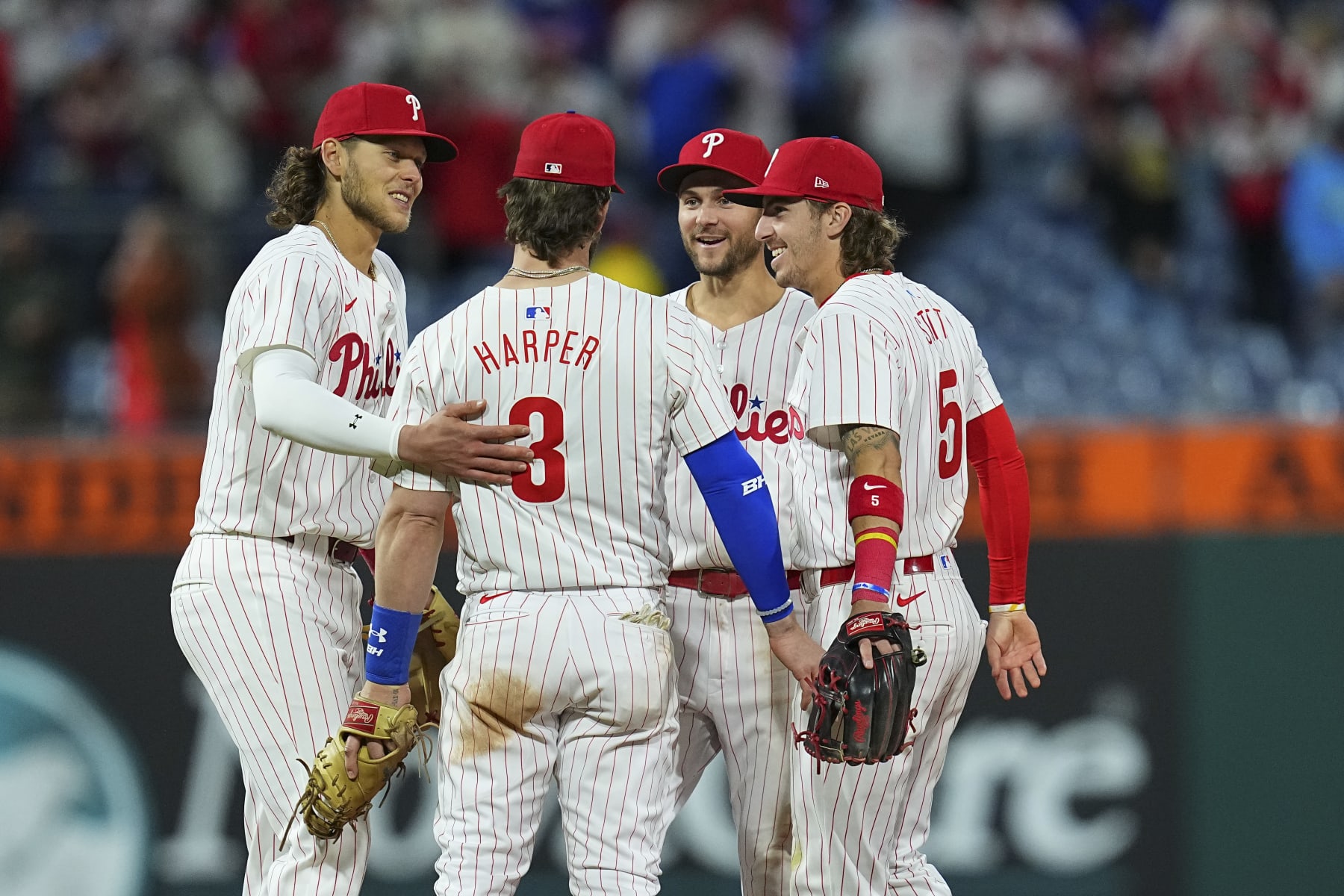 PHILADELPHIA, PENNSYLVANIA - APRIL 20: Alec Bohm #28, Trea Turner #7, Bryce Harper #3, and Bryson Stott #5 of the Philadelphia Phillies react against the Chicago White Sox at Citizens Bank Park on April 20, 2024 in Philadelphia, Pennsylvania. The Phillies defeated the White Sox 9-5. (Photo by Mitchell Leff/Getty Images)