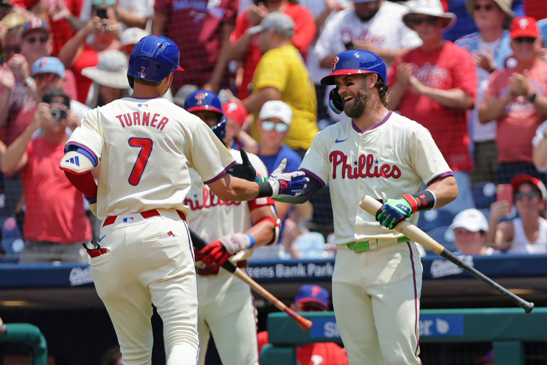PHILADELPHIA, PENNSYLVANIA - JULY 14: Trea Turner #7 of the Philadelphia Phillies is congratulated by teammate Bryce Harper #3  after Turner's solo home run in the first inning during a game against the Oakland Athletics at Citizens Bank Park on July 14, 2024 in Philadelphia, Pennsylvania. (Photo by Hunter Martin/Getty Images)