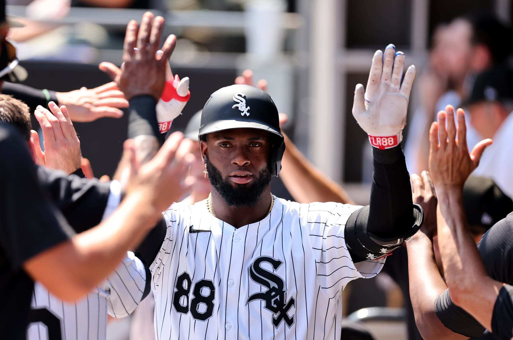 CHICAGO, ILLINOIS - JULY 10: Luis Robert Jr. #88 of the Chicago White Sox high fives teammates after hitting a two-run home run off Bailey Ober #17 of the Minnesota Twins (not pictured) during the sixth inning at Guaranteed Rate Field on July 10, 2024 in Chicago, Illinois. (Photo by Michael Reaves/Getty Images)