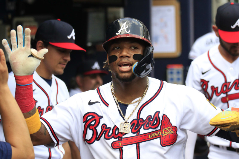 ATLANTA, GA - AUGUST 02: Atlanta Braves right fielder Ronald Acuna Jr. #13 is congratulated by his teammates after scoring during the MLB game between the Los Angeles Angels and the Atlanta Braves on August 2, 2023 at TRUIST Park in Atlanta, GA. (Photo by Jeff Robinson/Icon Sportswire via Getty Images)