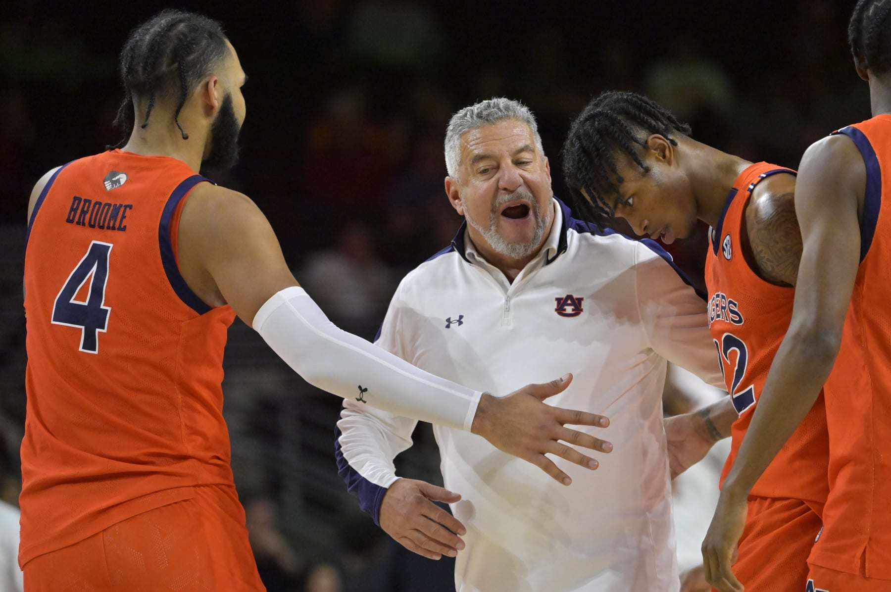 LOS ANGELES, CA - DECEMBER 18: Head coach Bruce Pearl talks with Johni Broome #4 and Allen Flanigan #22 of the Auburn Tigers during a time out in the first half against the USC Trojans at Galen Center on December 18, 2022 in Los Angeles, California. (Photo by Jayne Kamin-Oncea/Getty Images)