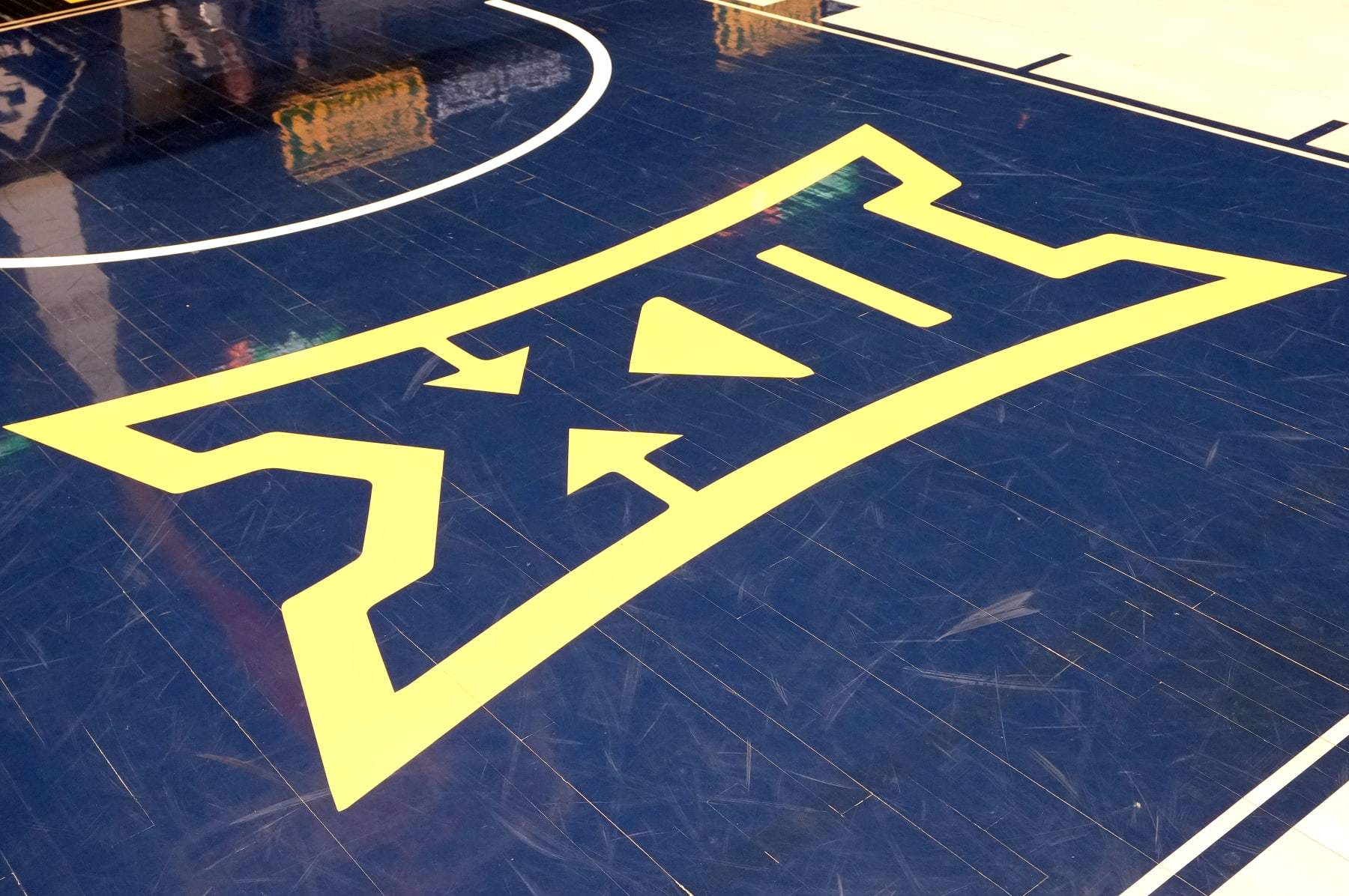 MORGANTOWN, WEST VIRGINIA - FEBRUARY 20: Big XII logo on the floor before a college basketball game between Oklahoma State Cowboys and the the West Virginia Mountaineers at the WVU Coliseum on February 20, 2023 in Morgantown, West Virginia. (Photo by Mitchell Layton/Getty Images)