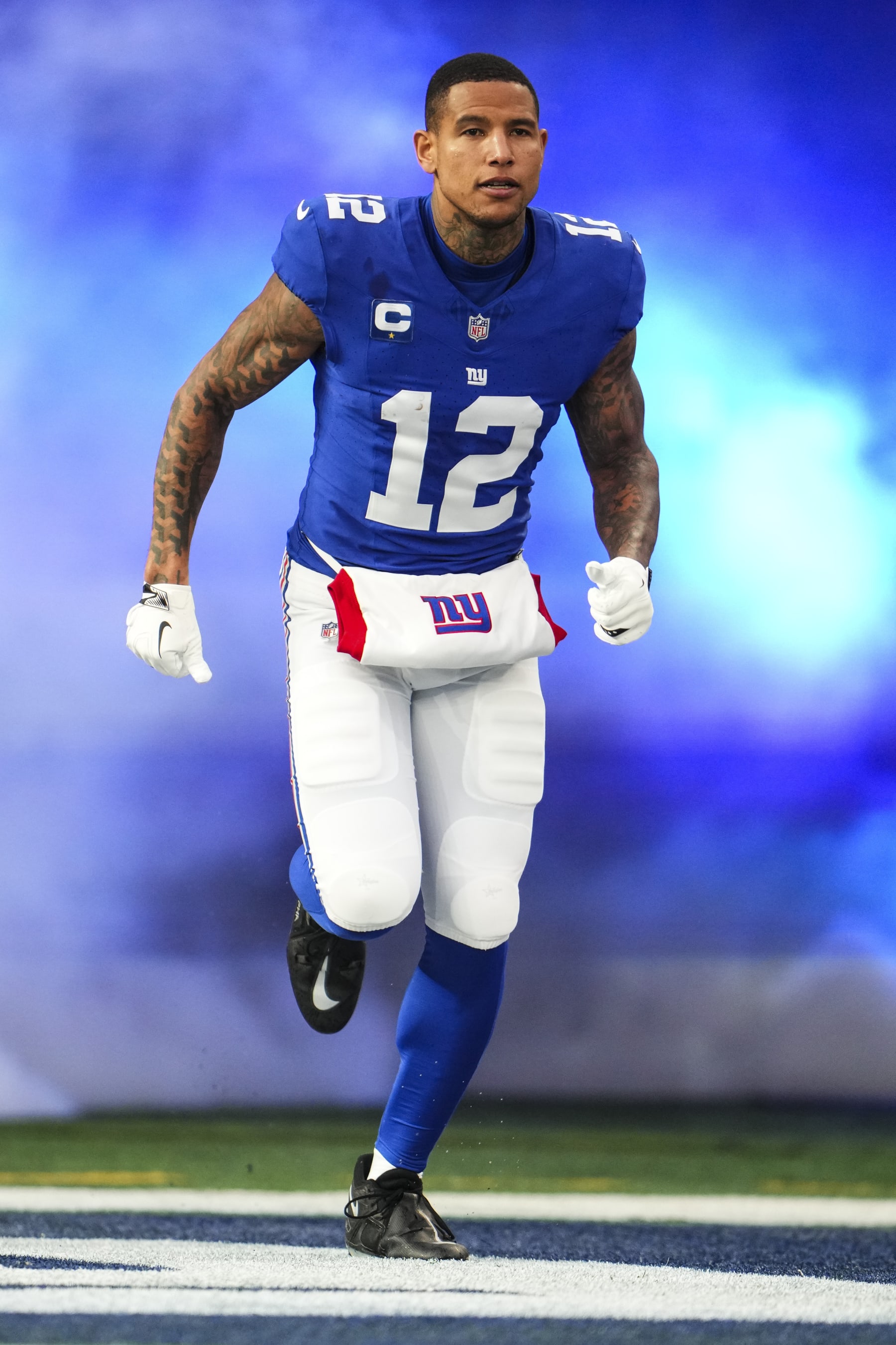EAST RUTHERFORD, NJ - JANUARY 07: Darren Waller #12 of the New York Giants runs out of the tunnel prior to an NFL football game against the Philadelphia Eagles at MetLife Stadium on January 7, 2024 in East Rutherford, New Jersey. (Photo by Cooper Neill/Getty Images)
