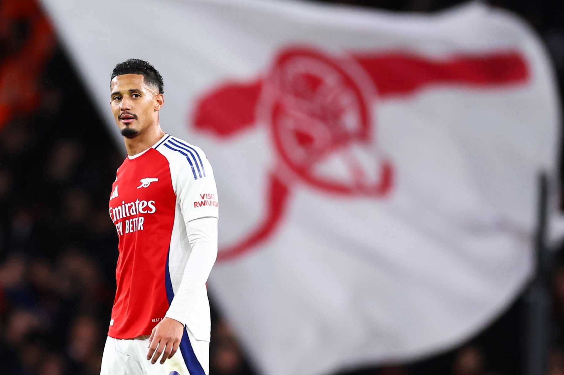 LONDON, ENGLAND - DECEMBER 3: William Saliba of Arsenal with a cannon flag behind him during the Premier League match between Arsenal FC and Manchester United FC at Emirates Stadium on December 3, 2024 in London, England. (Photo by Jacques Feeney/Offside/Offside via Getty Images)