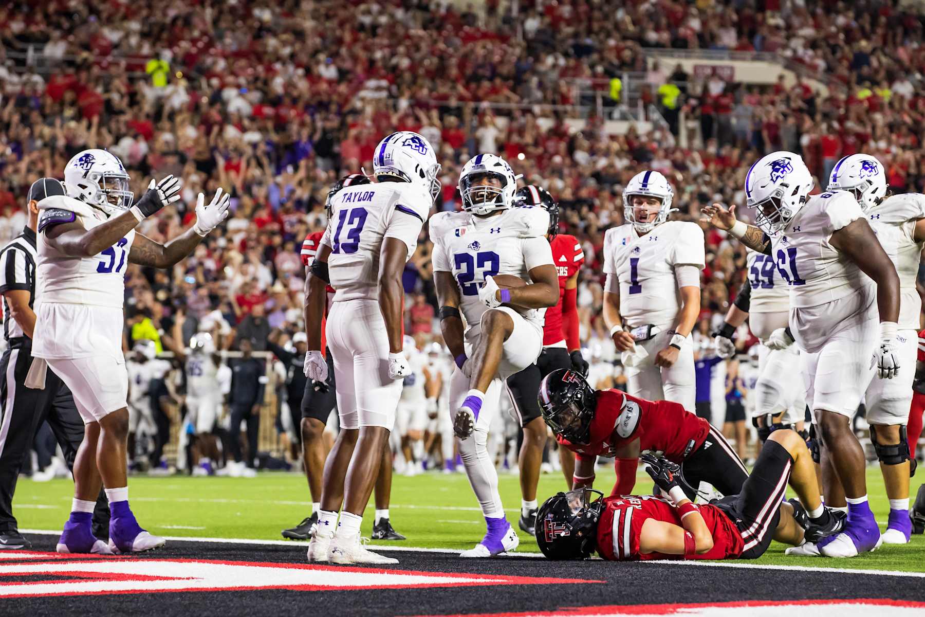 LUBBOCK, TEXAS - AUGUST 31: Isaiah Johnson #23 of the Abilene Christian Wildcats celebrates after scoring a touchdown during the second half of the game against the Texas Tech Red Raiders at Jones AT&T Stadium on August 31, 2024 in Lubbock, Texas. (Photo by John E. Moore III/Getty Images)