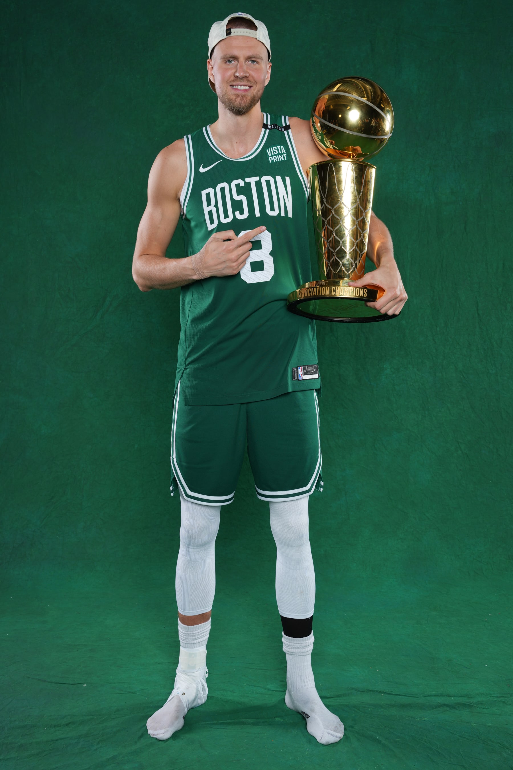 BOSTON, MA - JUNE 17: Kristaps Porzingis #8 of the Boston Celtics poses for a portrait with the Larry O'Brian Trophy after winning Game 5 of the 2024 NBA Finals on June 17, 2024 at the TD Garden in Boston, Massachusetts. NOTE TO USER: User expressly acknowledges and agrees that, by downloading and or using this photograph, User is consenting to the terms and conditions of the Getty Images License Agreement. Mandatory Copyright Notice: Copyright 2024 NBAE  (Photo by Jesse D. Garrabrant/NBAE via Getty Images)