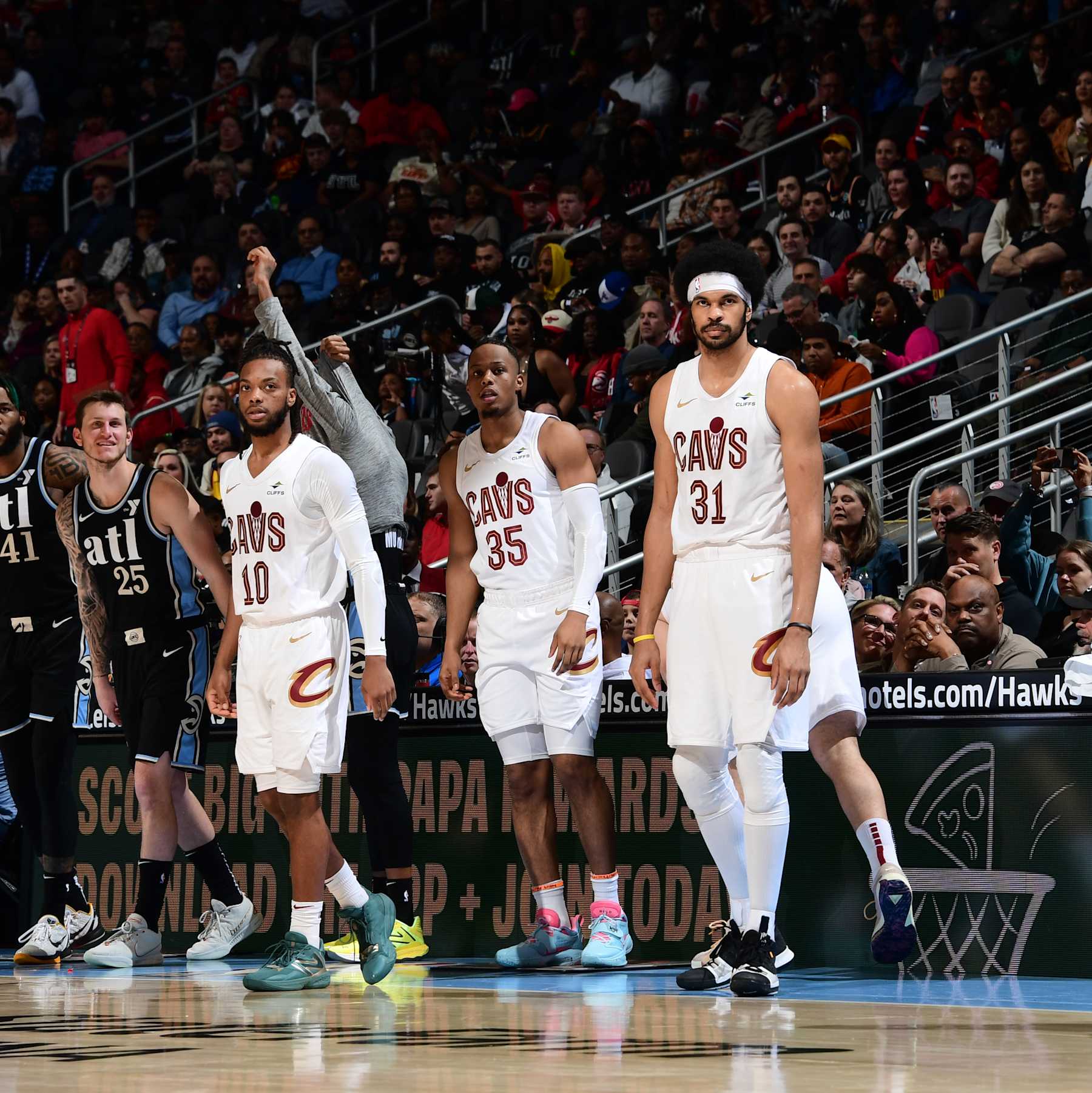 ATLANTA, GA - MARCH 6: Darius Garland #10, Isaac Okoro #35, and Jarrett Allen #31 of the Cleveland Cavaliers look on during the game against the Atlanta Hawks on March 6, 2024 at State Farm Arena in Atlanta, Georgia.  NOTE TO USER: User expressly acknowledges and agrees that, by downloading and/or using this Photograph, user is consenting to the terms and conditions of the Getty Images License Agreement. Mandatory Copyright Notice: Copyright 2024 NBAE (Photo by Scott Cunningham/NBAE via Getty Images)