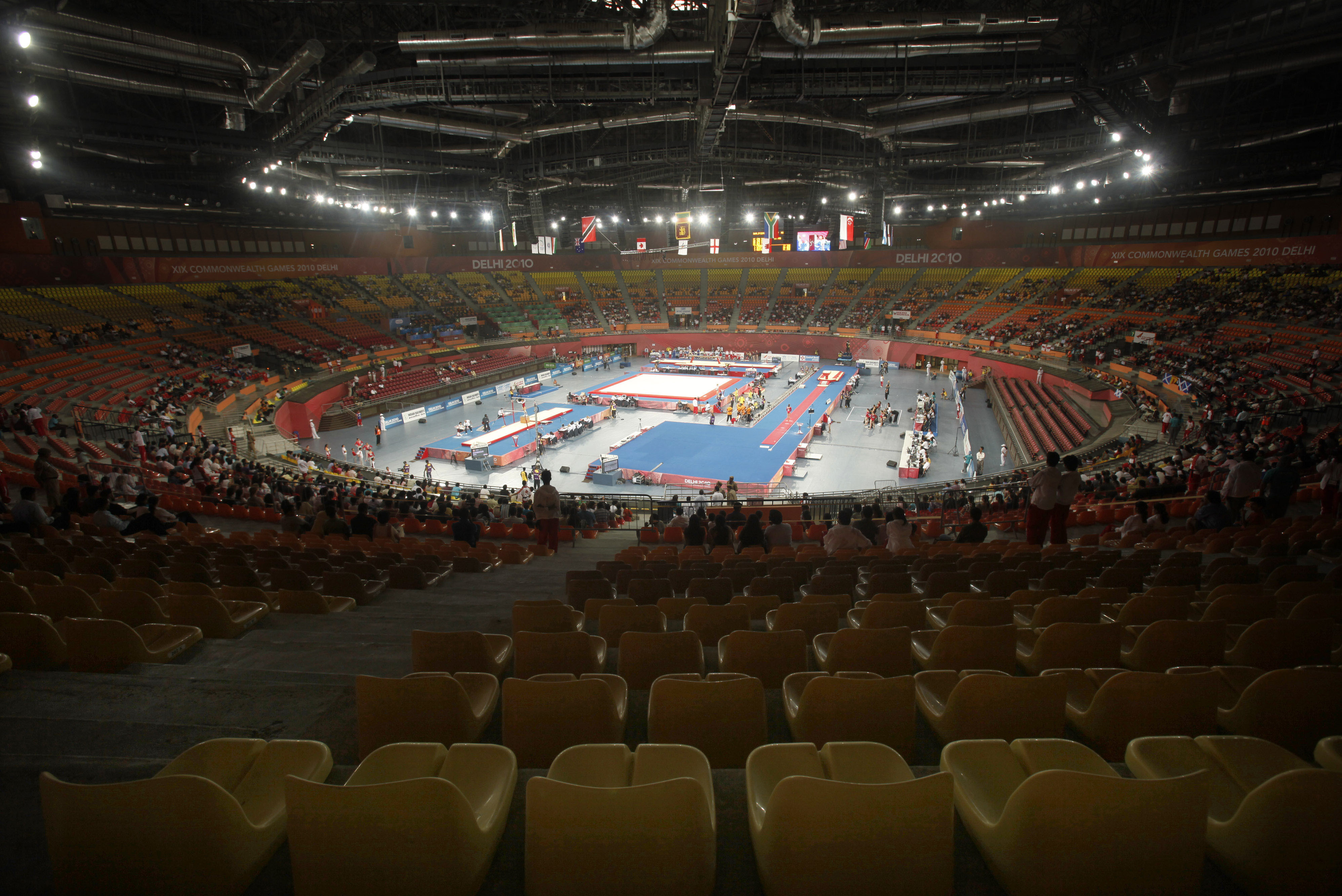Spectators' seats lie poorly during a gymnastics event in Indira Gandhi Sports Complex in New Delhi, India, Tuesday, Oct. 5, 2010. The empty stadiums that marred the first day of competition at the crisis-hit Commonwealth Games may be filled by children and the underprivileged if attendance doesn't improve. (AP Photo/Anupam Nath)