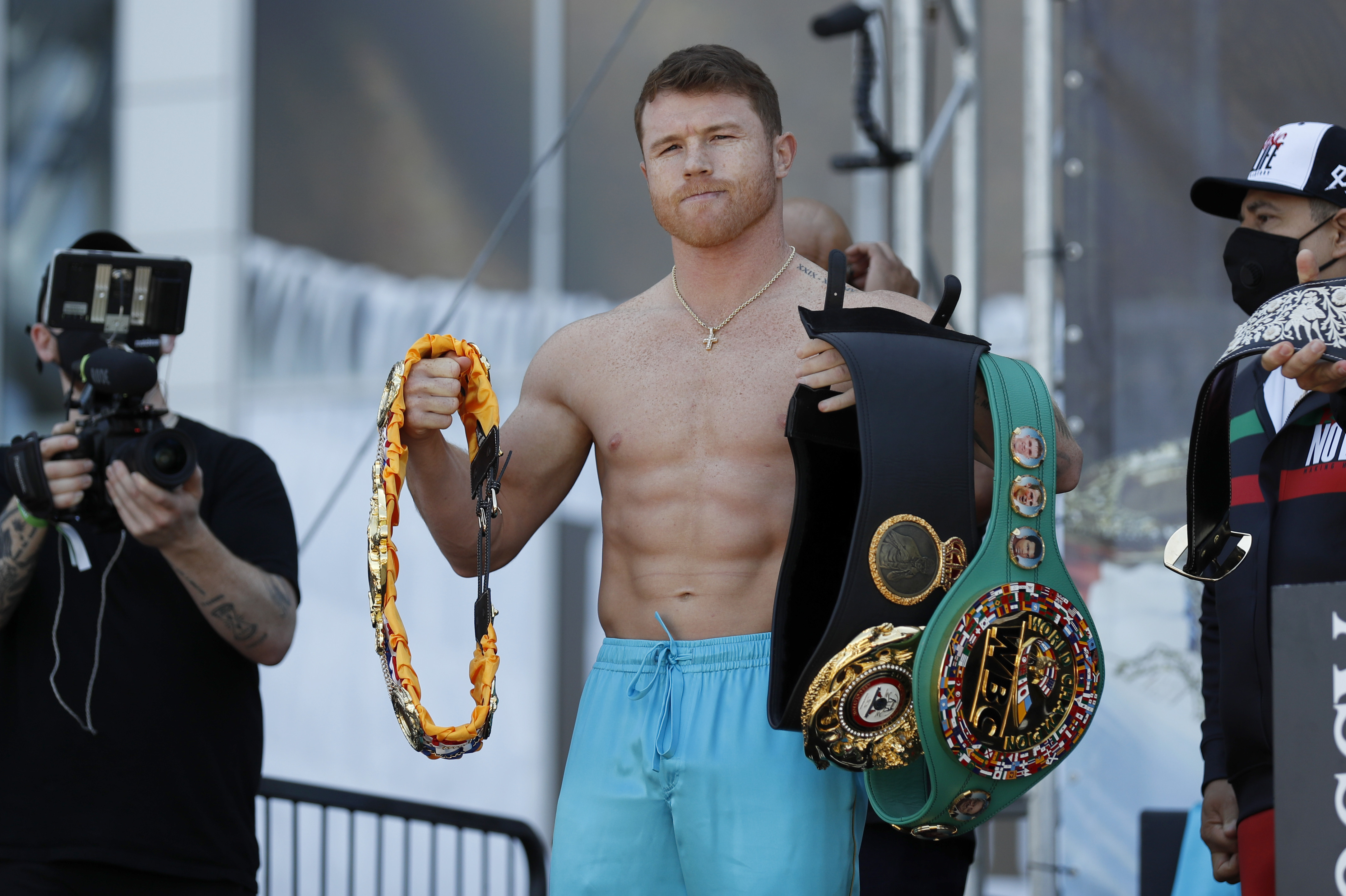 Canelo Alvarez poses for photos with his championship belts after his weigh-in for his title match against Billy Joe Saunders, Friday, May 7, 2021, in Arlington, Texas. Alvarez and Saunders fight on Saturday, May 8, 2021, for the unified super middleweight world championship. (AP Photo/Roger Steinman)