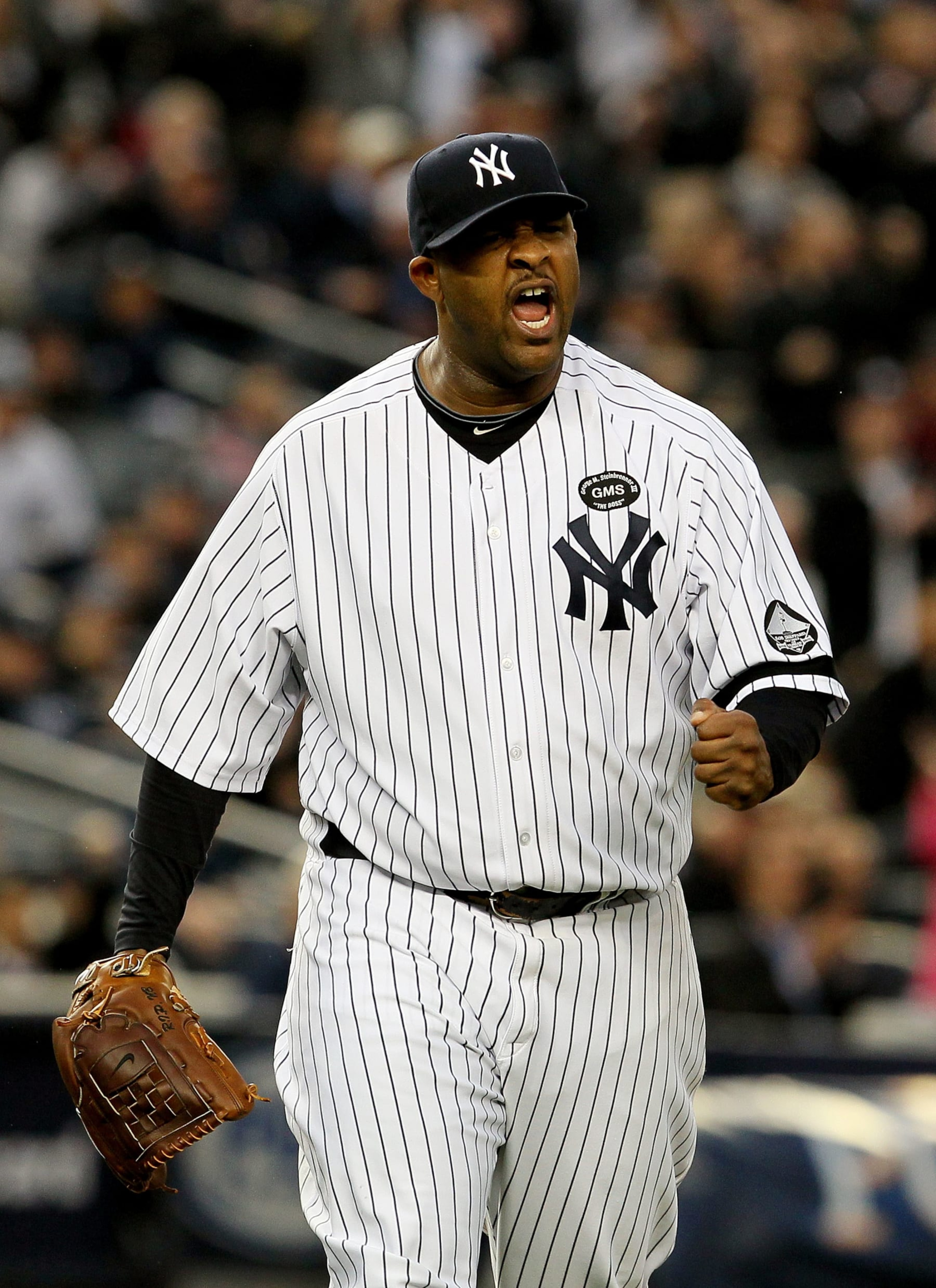 NEW YORK - OCTOBER 20:  CC Sabathia #52 of the New York Yankees celebrates after he forced Josh Hamilton #32 of the Texas Rangers to ground into a double play to end the top of the fifth inning of Game Five of the ALCS during the 2010 MLB Playoffs at Yankee Stadium on October 20, 2010 in the Bronx borough of New York City.  (Photo by Jim McIsaac/Getty Images)
