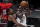 Milwaukee Bucks guard Jrue Holiday (21) drives against Atlanta Hawks forward Cam Reddish (22) during the first half of Game 6 of the Eastern Conference finals in the NBA basketball playoffs Saturday, July 3, 2021, in Atlanta. (AP Photo/John Bazemore)
