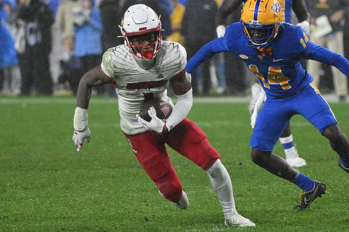 PITTSBURGH, PENNSYLVANIA - OCTOBER 14: Jamari Thrash #1 of the Louisville Cardinals runs after a catch under pressure from Marquis Williams #14 of the Pittsburgh Panthers in the second quarter during the game at Acrisure Stadium on October 14, 2023 in Pittsburgh, Pennsylvania. (Photo by Justin Berl/Getty Images)