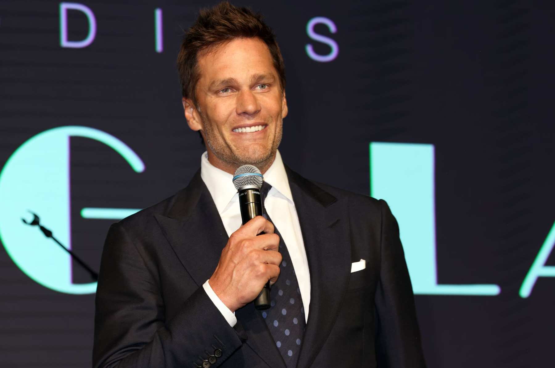 MIAMI, FLORIDA - NOVEMBER 17: Tom Brady speaks on stage at the 25th Annual Best Buddies Miami Gala at Ice Palace Film Studios on November 17, 2023 in Miami, Florida. (Photo by Alexander Tamargo/Getty Images for Best Buddies)