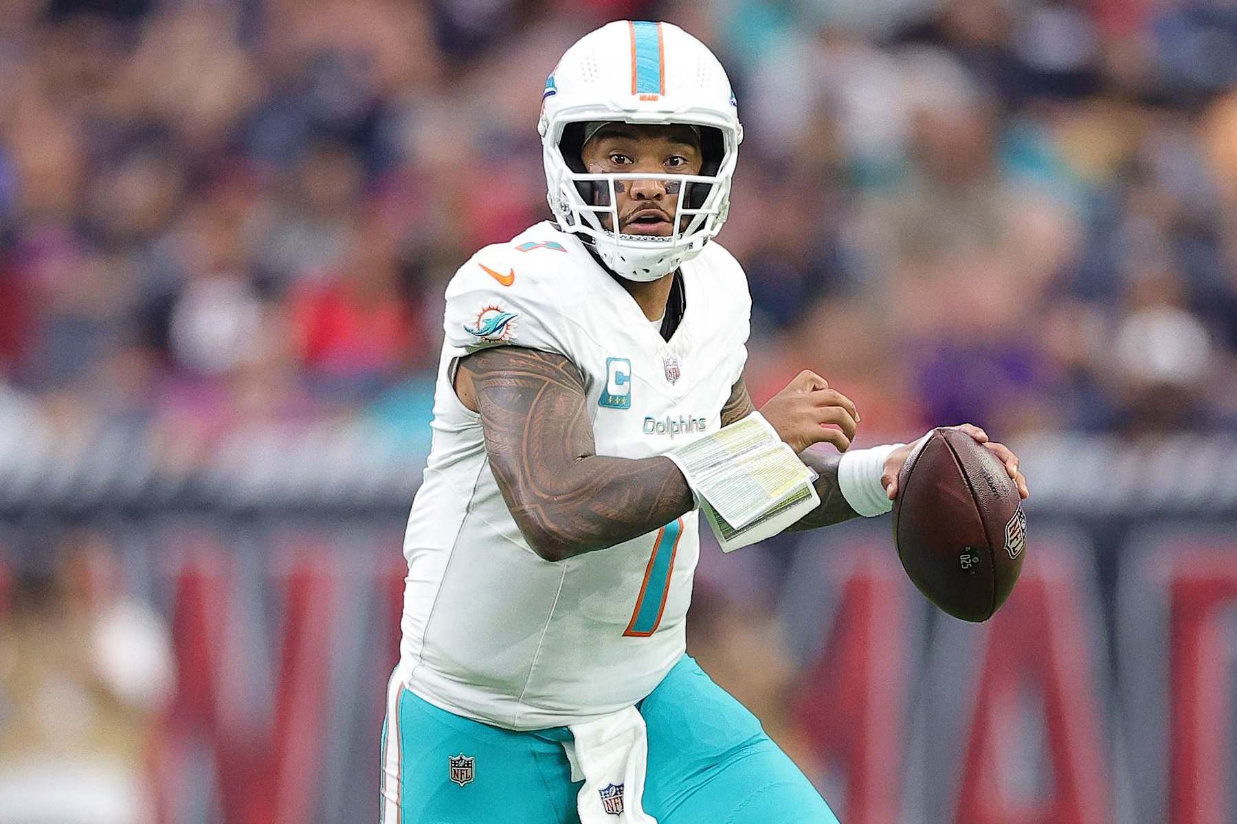HOUSTON, TEXAS - DECEMBER 15: Tua Tagovailoa #1 of the Miami Dolphins runs the ball against the Houston Texans during the second quarter at NRG Stadium on December 15, 2024 in Houston, Texas. (Photo by Alex Slitz/Getty Images)