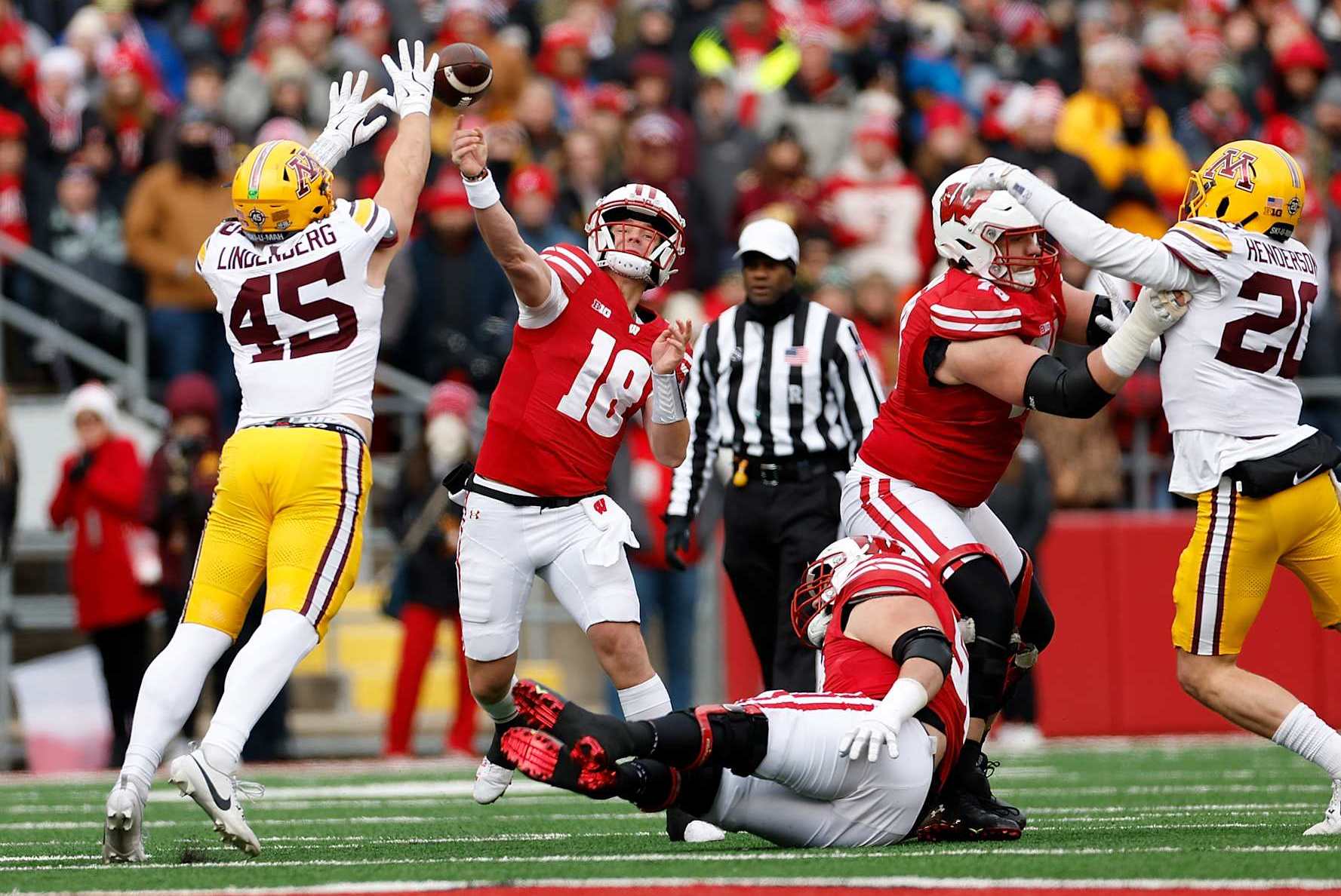 MADISON, WISCONSIN - NOVEMBER 29: Braedyn Locke #18 of the Wisconsin Badgers throws a pass in the first quarter against the Minnesota Golden Gophers at Camp Randall Stadium on November 29, 2024 in Madison, Wisconsin. (Photo by John Fisher/Getty Images)