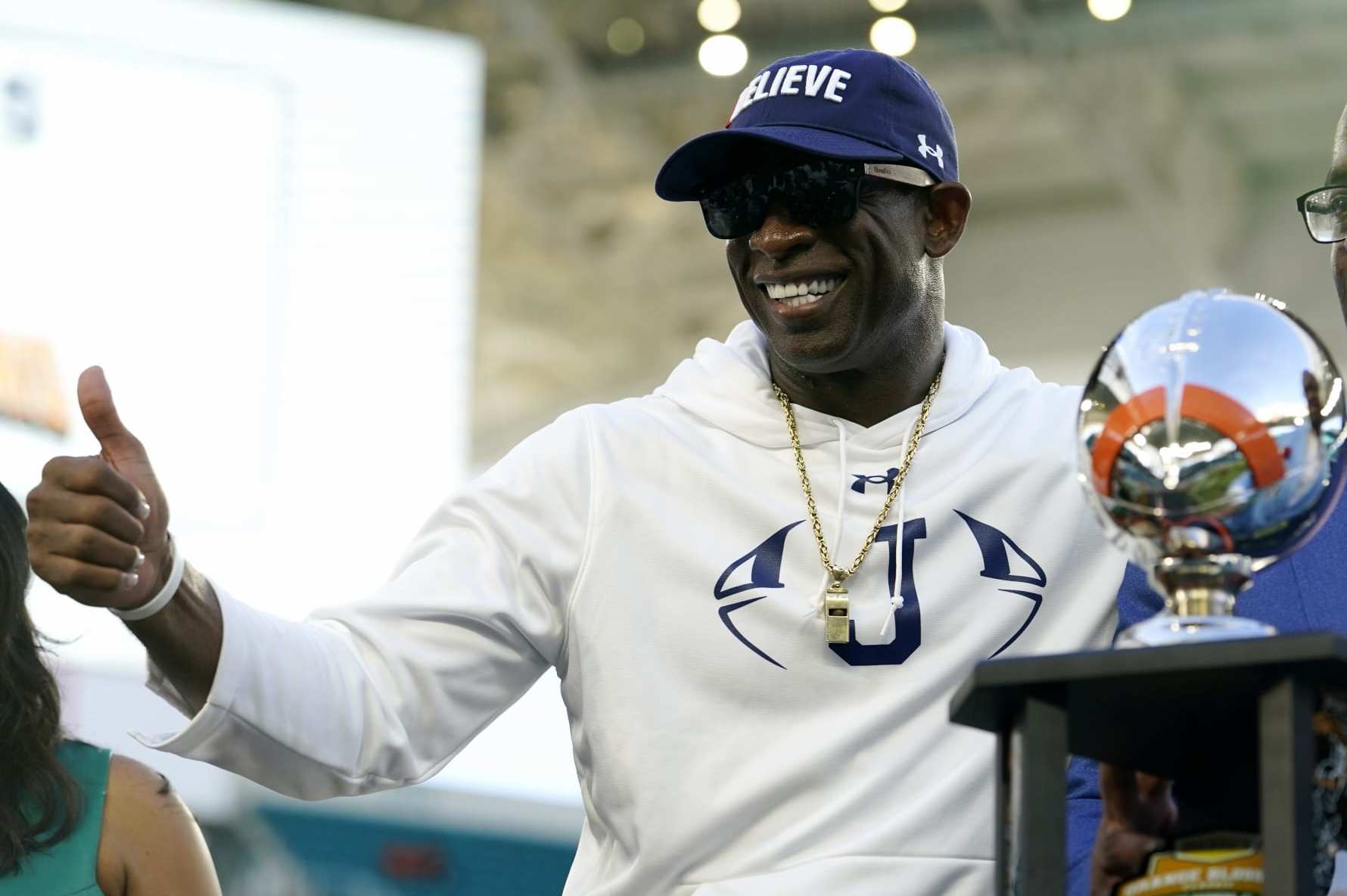 Jackson State head coach Deion Sanders poses with the trophy after the Orange Blossom Classic NCAA college football game against against Florida A&M, Sunday, Sept. 4, 2022, in Miami Gardens, Fla. (AP Photo/Lynne Sladky)
