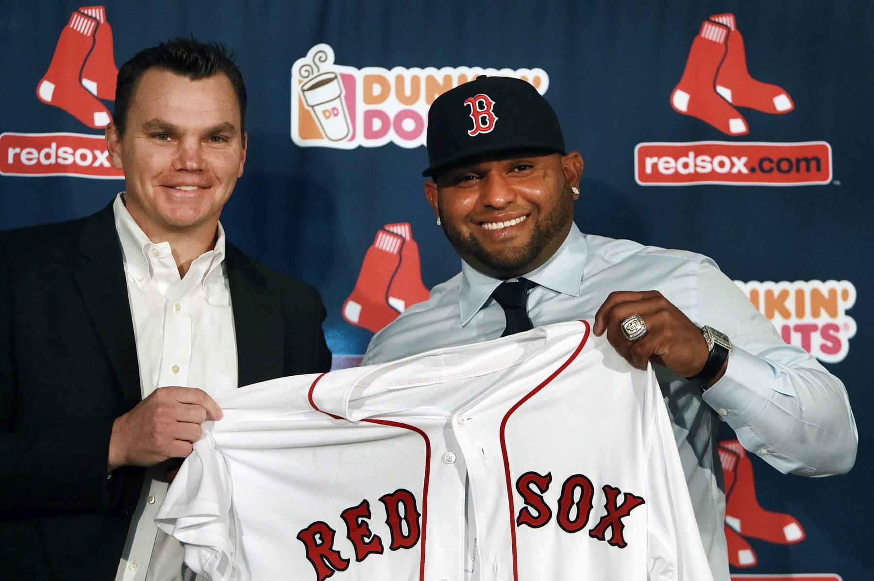 BOSTON - NOVEMBER 25: The Boston Red Sox introduced newly signed third baseman Pablo Sandoval, right, at a press conference at Fenway Park. Sandoval holding up his new jersey with general manager Ben Cherington, left. A World Series ring from his days with the San Francisco Giants is on his left hand. (Photo by Jim Davis/The Boston Globe via Getty Images)