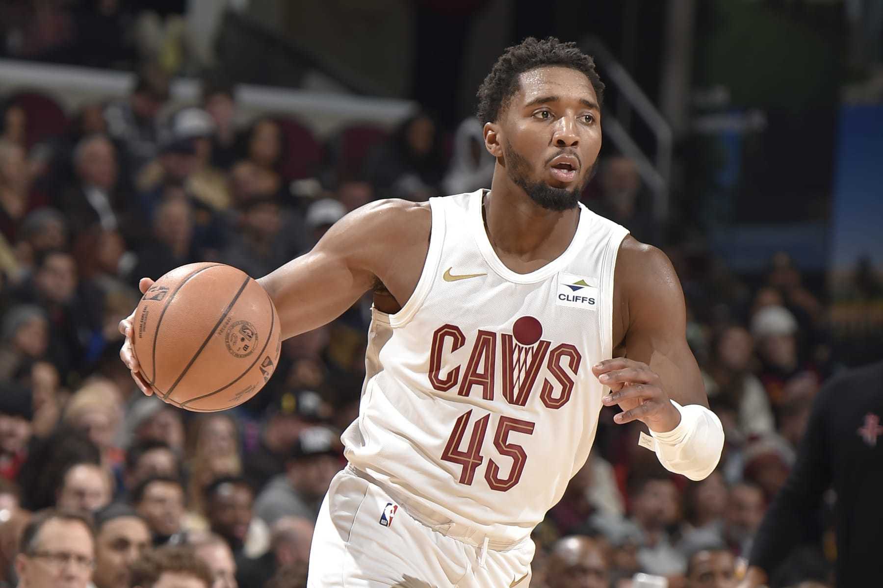 CLEVELAND, OH - DECEMBER 18: Donovan Mitchell #45 of the Cleveland Cavaliers brings the ball up court against the Houston Rockets on December 18, 2023 at Rocket Mortgage FieldHouse in Cleveland, Ohio. NOTE TO USER: User expressly acknowledges and agrees that, by downloading and/or using this Photograph, user is consenting to the terms and conditions of the Getty Images License Agreement. Mandatory Copyright Notice: Copyright 2023 NBAE (Photo by David Liam Kyle/NBAE via Getty Images)