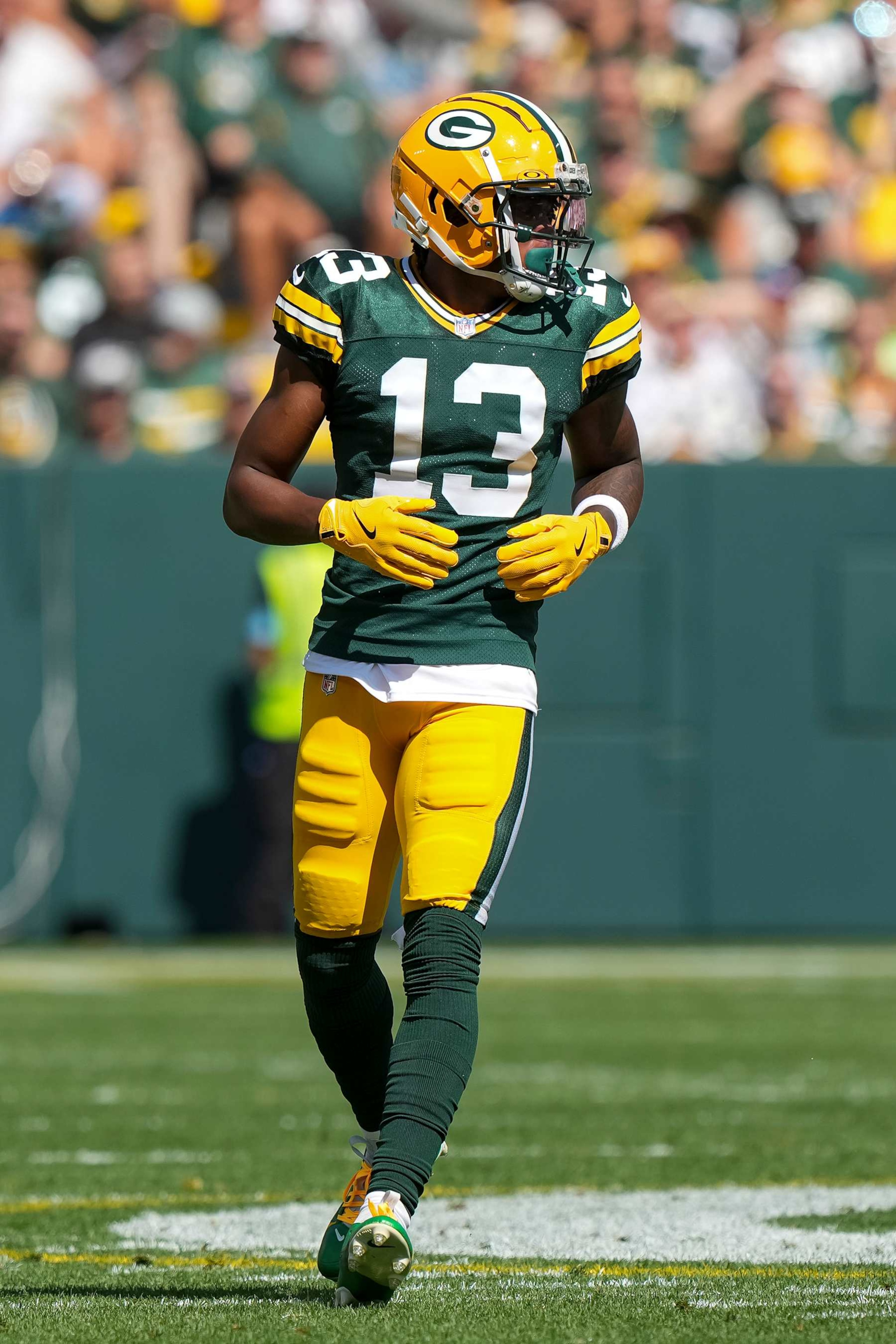 GREEN BAY, WI - SEPTEMBER 15: Wide receiver Dontayvion Wicks #13 of the Green Bay Packers gets set during the first quarter of an NFL football game against the Indianapolis Colts, at Lambeau Field on September 15, 2024 in Green Bay, Wisconsin. (Photo by Todd Rosenberg/Getty Images)