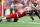 MADISON, WISCONSIN - NOVEMBER 05: Keeanu Benton #95 of the Wisconsin Badgers sacks Taulia Tagovailoa #3 of the Maryland Terrapins in the first quarter against the Wisconsin Badgers at Camp Randall Stadium on November 05, 2022 in Madison, Wisconsin. (Photo by John Fisher/Getty Images)