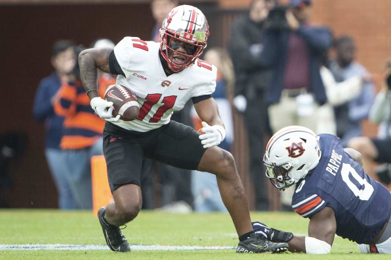 AUBURN, ALABAMA - NOVEMBER 19: Wide receiver Malachi Corley #11 of the Western Kentucky Hilltoppers maneuvers the ball by linebacker Owen Pappoe #0 of the Auburn Tigers during the first half of play at Jordan-Hare Stadium on November 19, 2022 in Auburn, Alabama. (Photo by Michael Chang/Getty Images)