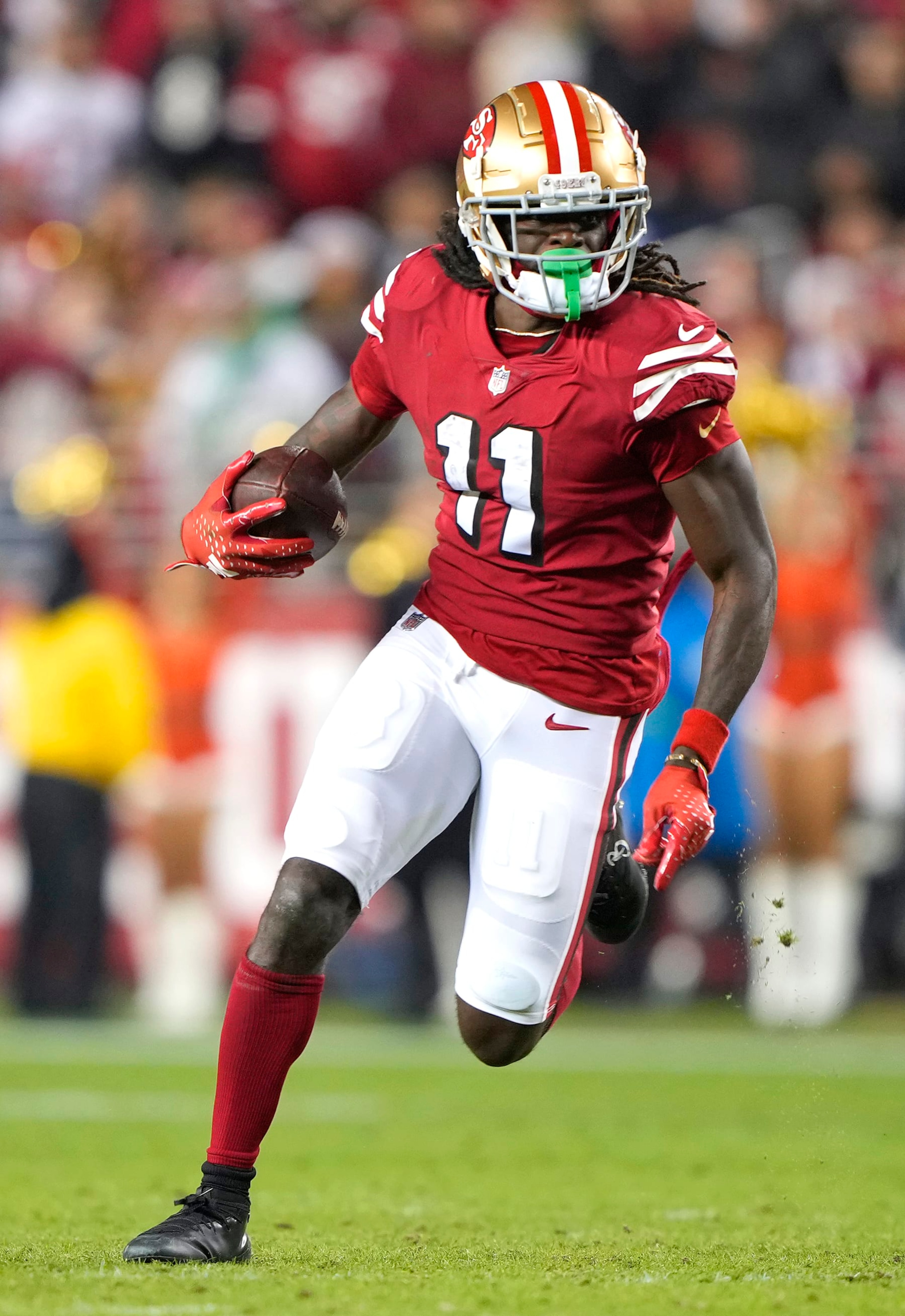 SANTA CLARA, CALIFORNIA - DECEMBER 25: Brandon Aiyuk #11 of the San Francisco 49ers runs with the ball after catching a pass against the Baltimore Ravens during the fourth quarter of an NFL football game at Levi's Stadium on December 25, 2023 in Santa Clara, California. (Photo by Thearon W. Henderson/Getty Images) SANTA CLARA, CALIFORNIA - DECEMBER 25: Brandon Aiyuk #11 of the San Francisco 49ers runs with the ball after catching a pass against the Baltimore Ravens during the fourth quarter of an NFL football game at Levi's Stadium on December 25, 2023 in Santa Clara, California. (Photo by Thearon W. Henderson/Getty Images)