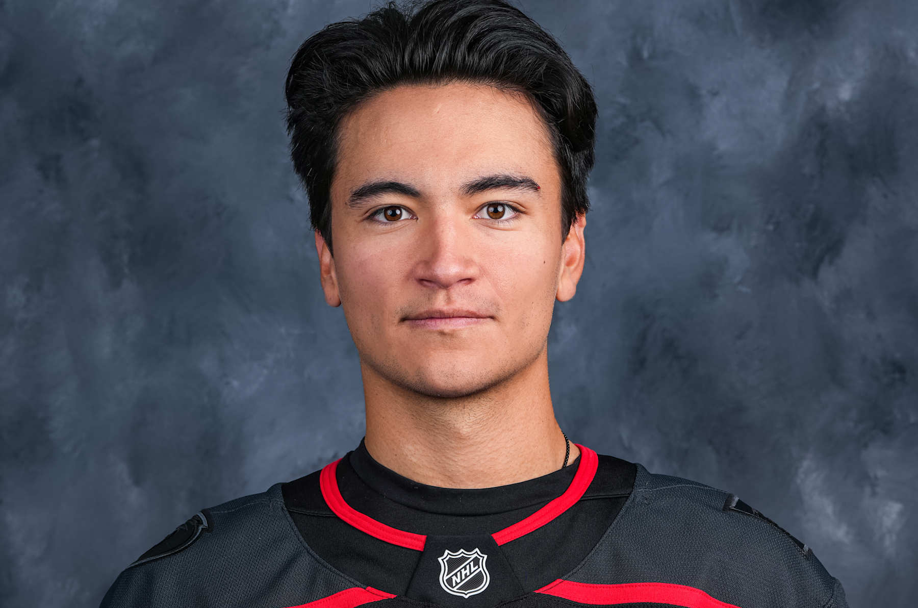 RALEIGH, NORTH CAROLINA - SEPTEMBER 19: Ryan Suzuki #16 of the Carolina Hurricanes poses for his official NHL headshot for the 2024-2025 season at Lenovo Center on September 19, 2024 in Raleigh, North Carolina. (Photo by Josh Lavallee/NHLI via Getty Images)