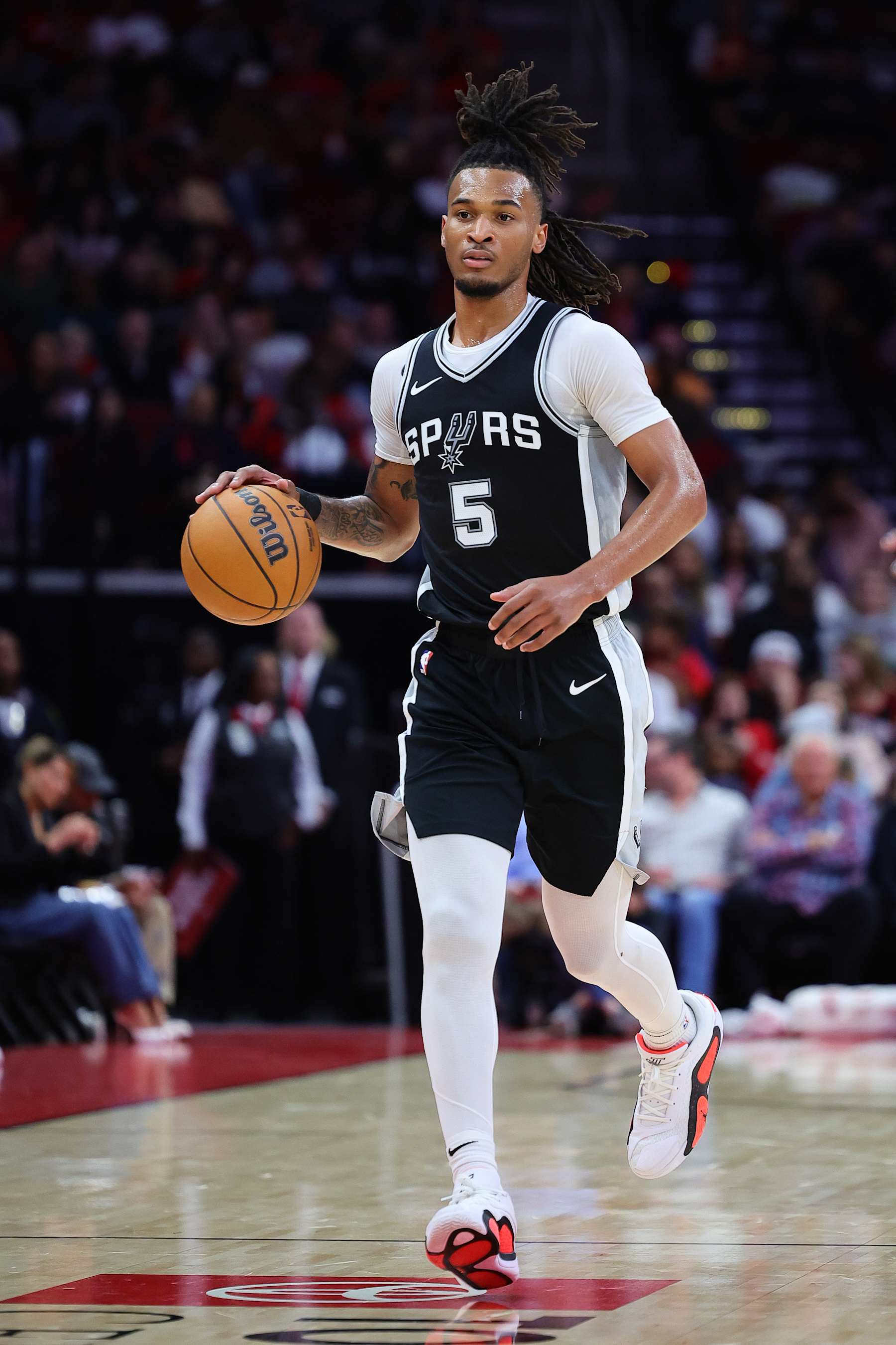 HOUSTON, TEXAS - OCTOBER 17: Stephon Castle #5 of the San Antonio Spurs dribbles down court against the Houston Rockets during the second half of a preseason game at Toyota Center on October 17, 2024 in Houston, Texas. NOTE TO USER: User expressly acknowledges and agrees that, by downloading and or using this photograph, User is consenting to the terms and conditions of the Getty Images License Agreement. (Photo by Alex Slitz/Getty Images)